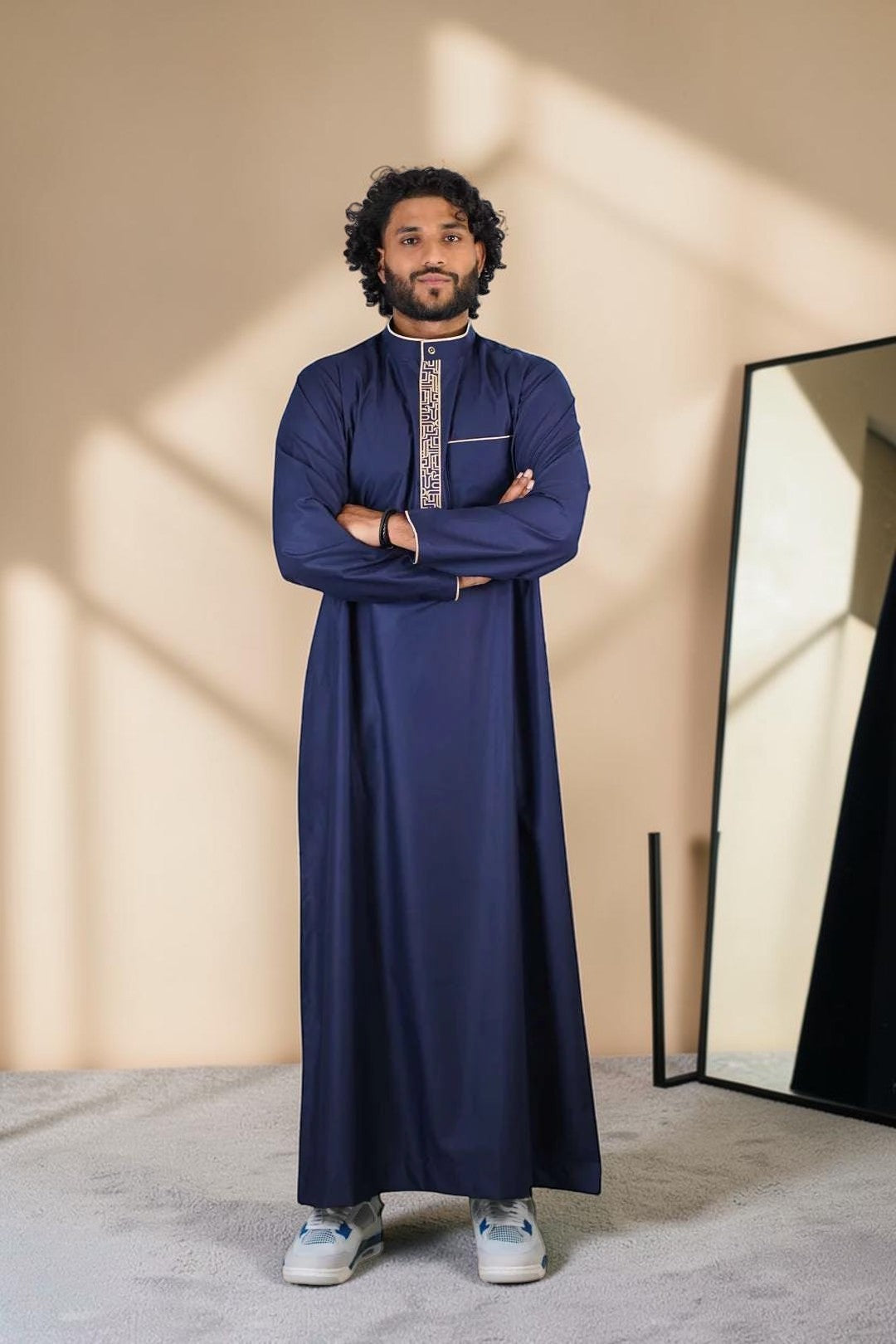 Navy blue and beige thobe with geometric embroidery for men, close-up of the fabric