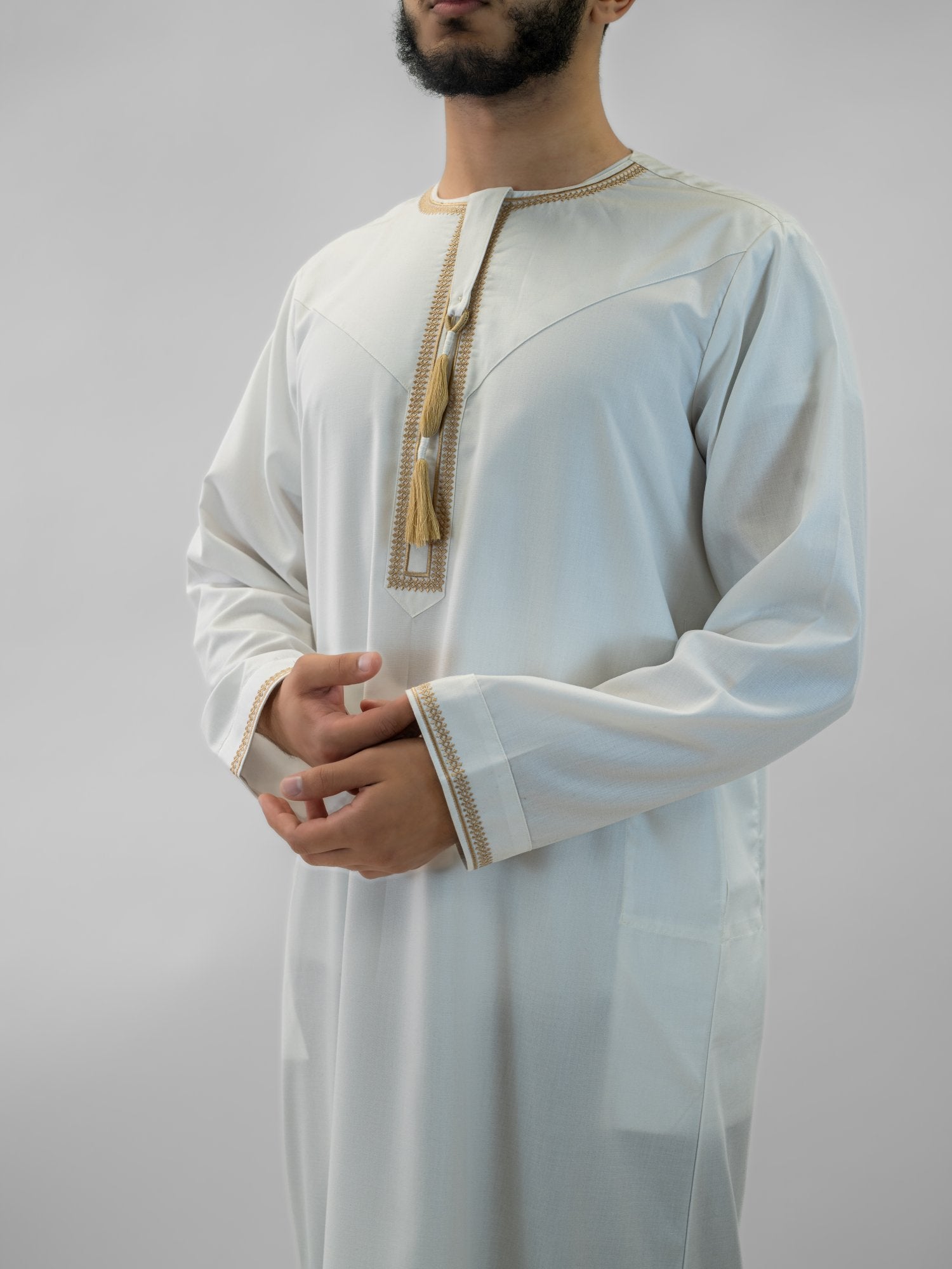 White emirati with tarboush cap thobe for men, worn by a model outdoors