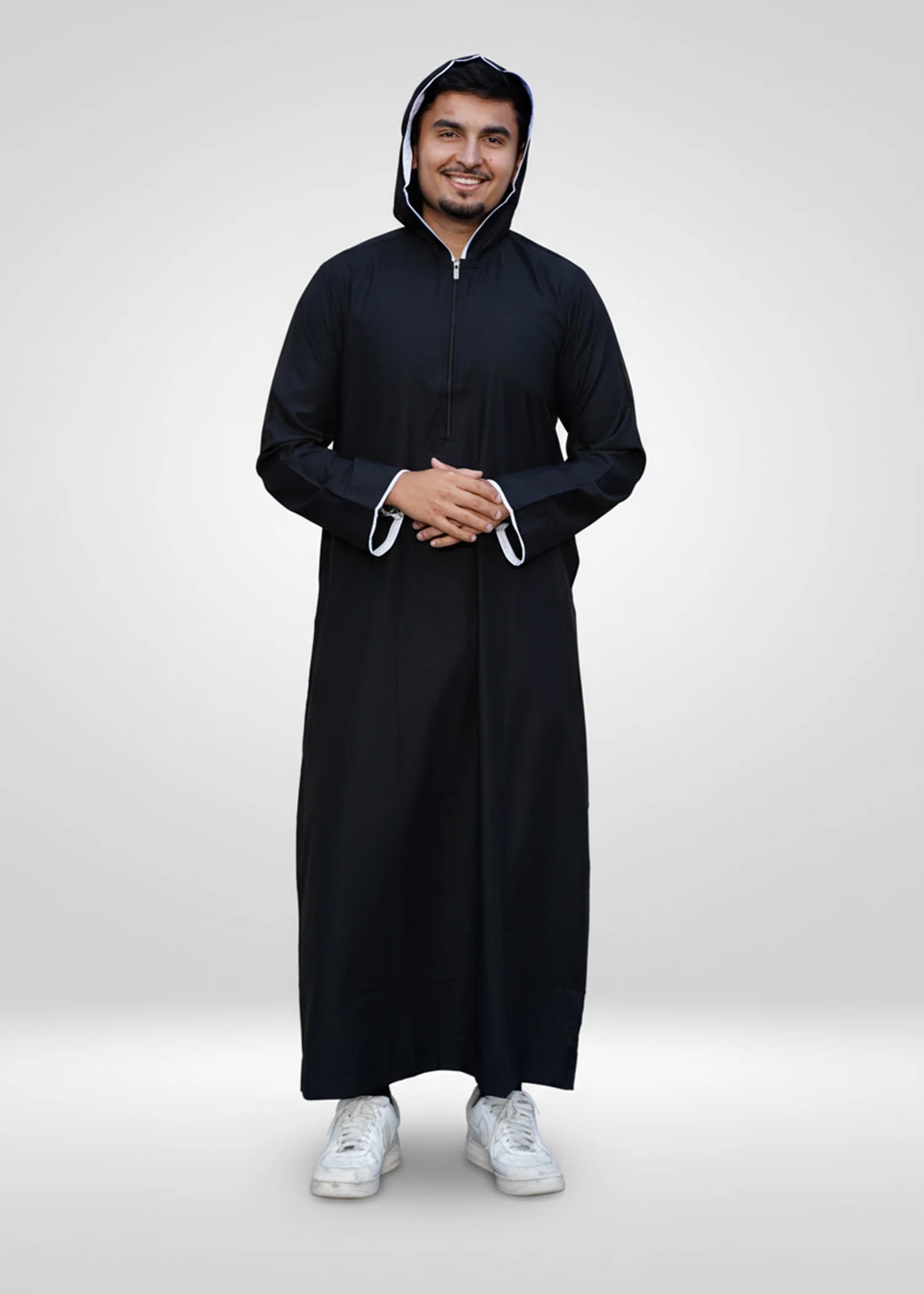 Side profile view of the men's black thobe showing the modern hooded silhouette and relaxed fit