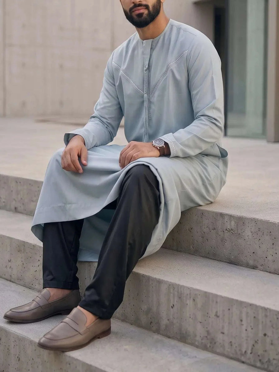 Man wearing light blue thobe with straight cut pants, shop men's trousers