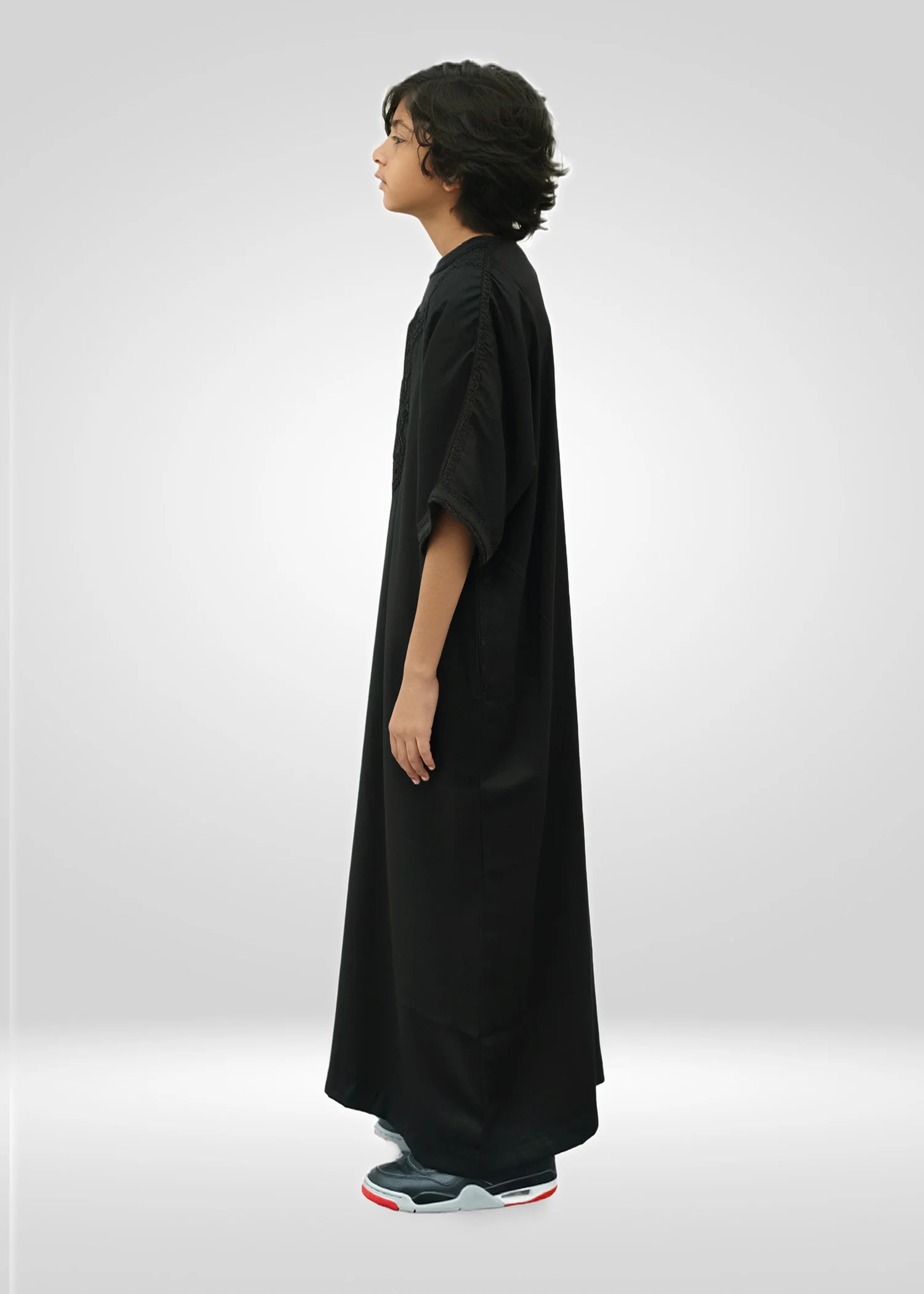 Side view of the black gandora showing the breezy short sleeve design and loose drape