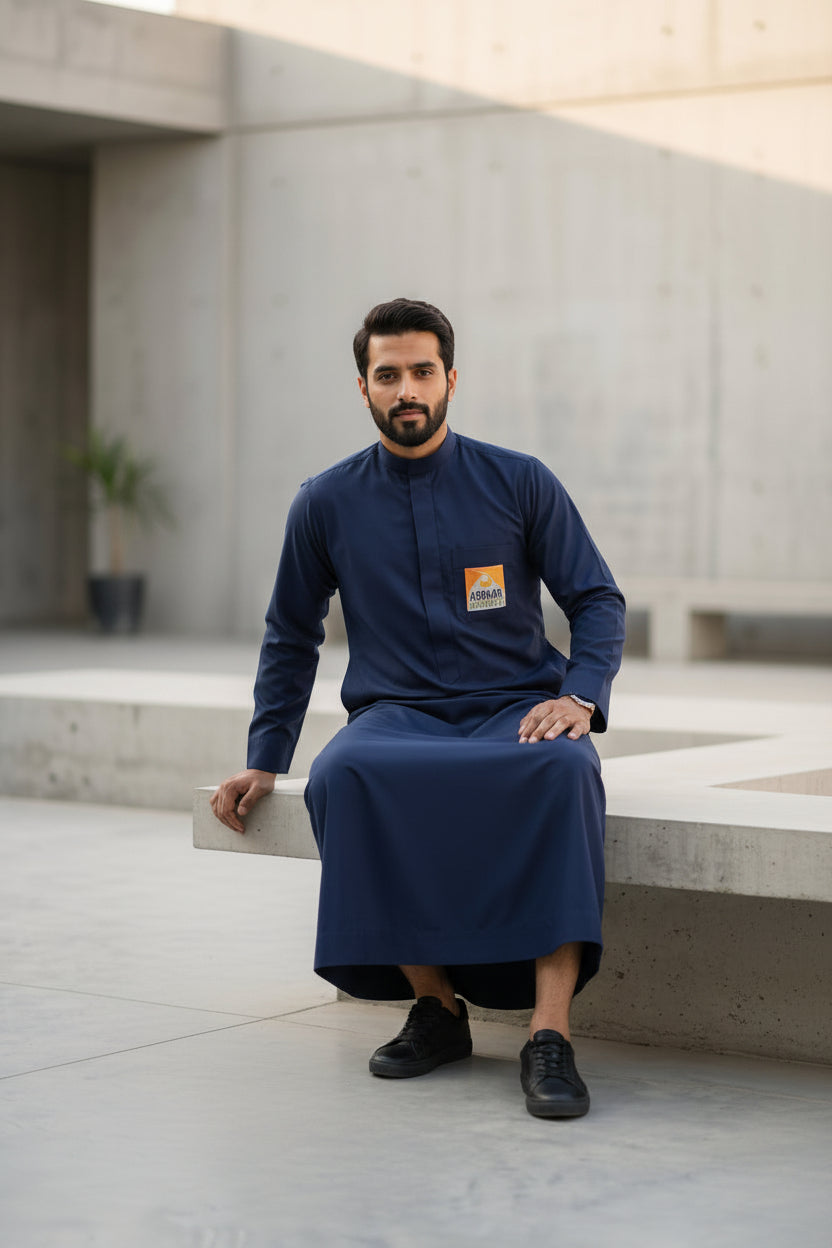 Official Abraar Academy navy blue men's uniform thobe with custom logo patch.