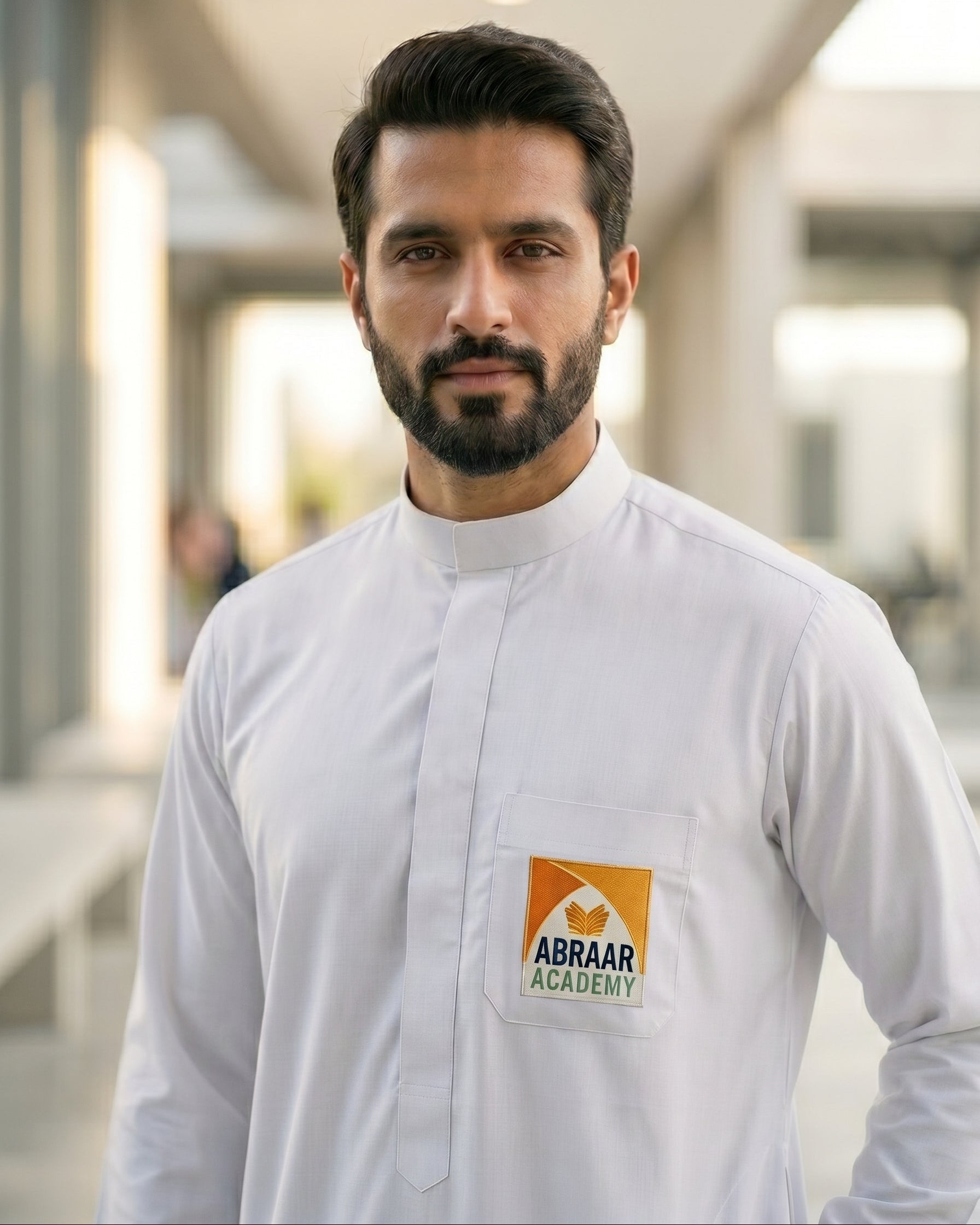 Official Abraar Academy men's white uniform thobe, Islamic school uniform for senior students and teachers, durable white jubbah with school logo, everyday school wear, neat traditional student attire.