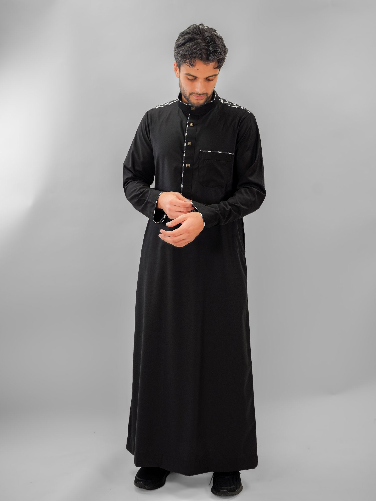 Black embroidered mandarin collar thobe for men, close-up of the fabric