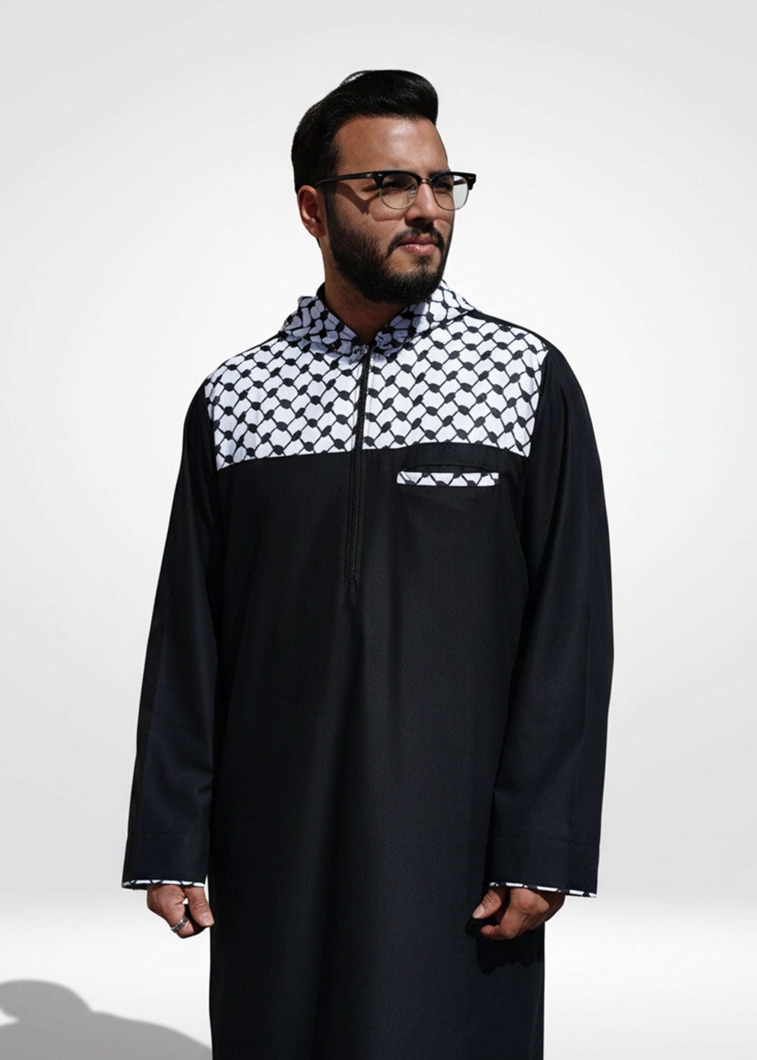Black hooded thobe with Kufiya panel for men, close-up of the embroidered detailing
