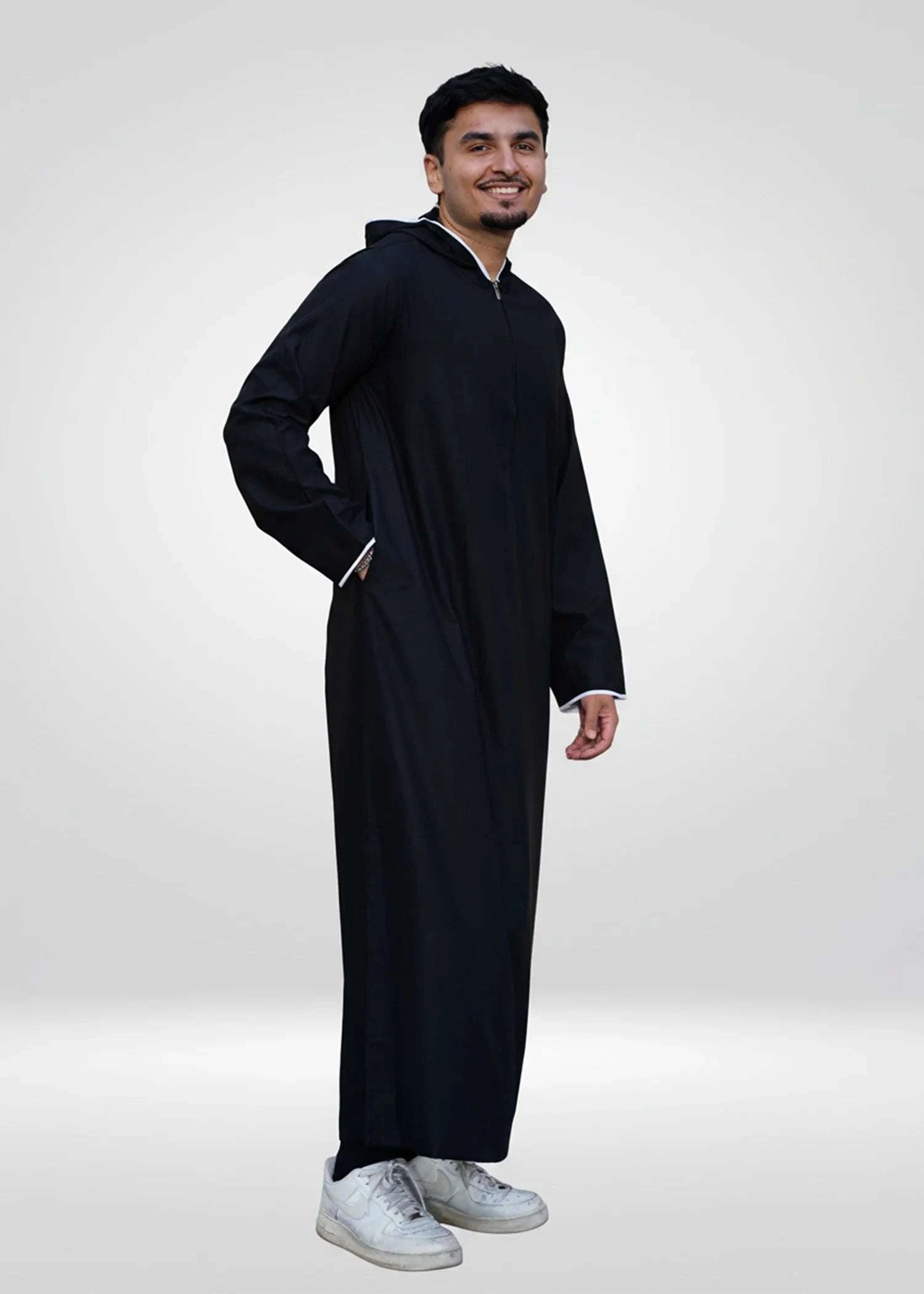 Black hooded thobe with sporty trim for men, worn by a model outdoors