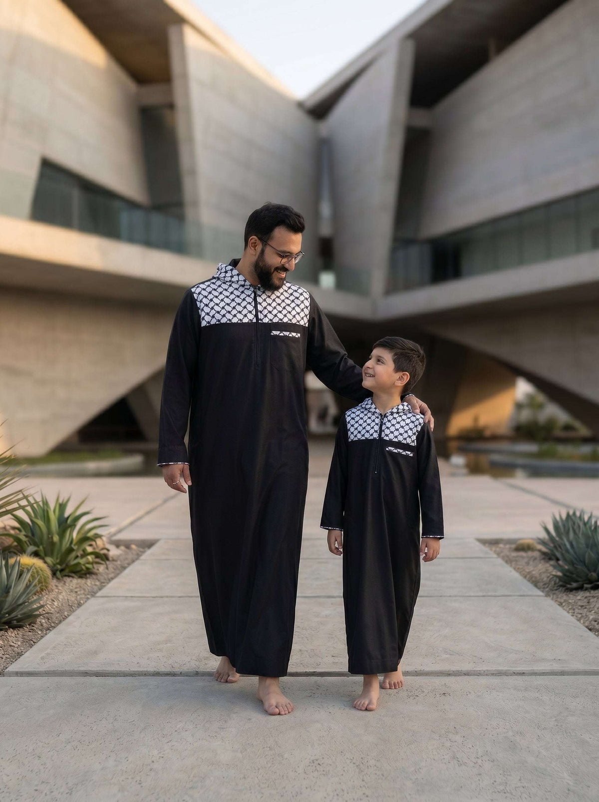 Black Palestine hoodie thobe with Kufiya pattern for men and boys, side profile view
