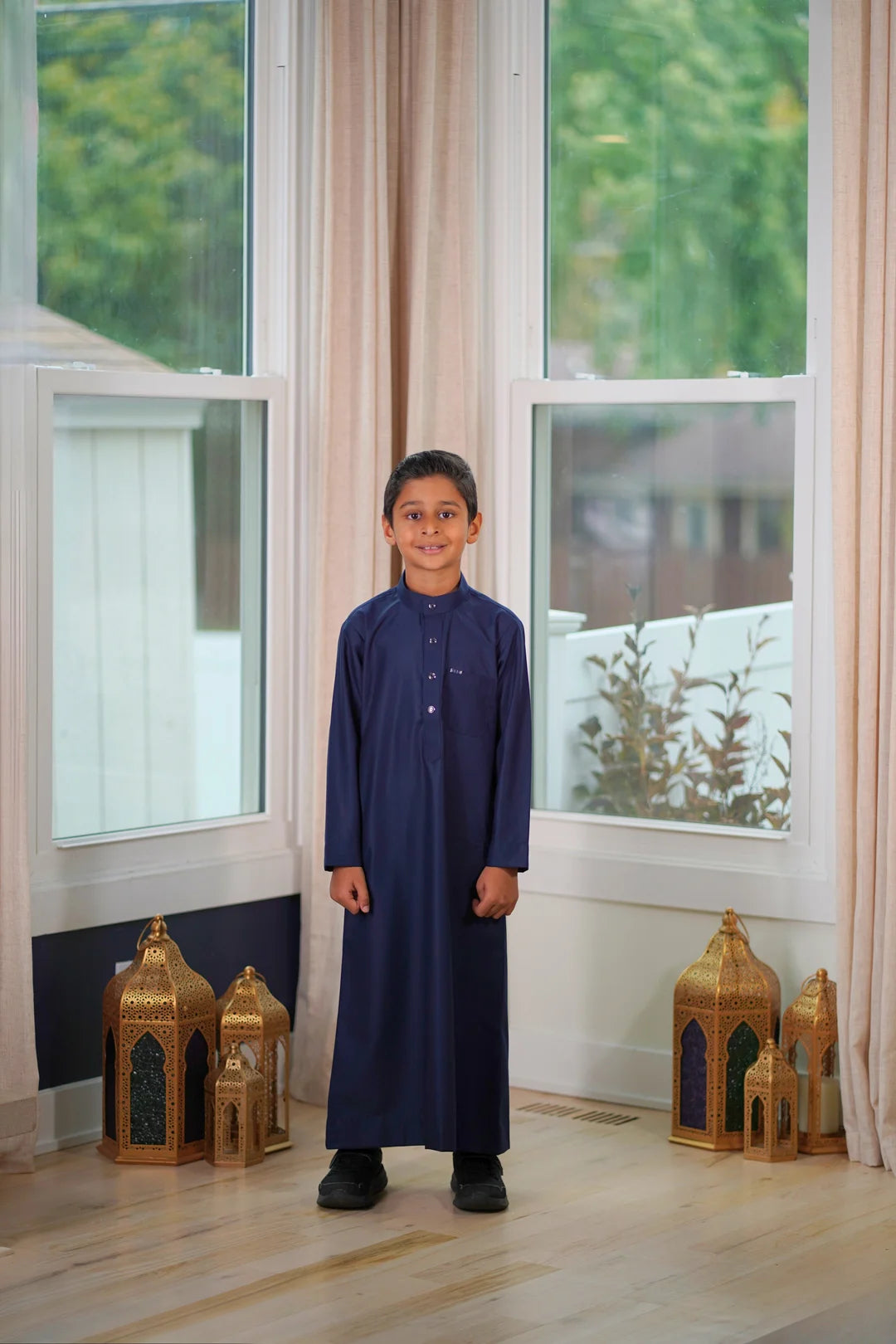 Side view of the navy blue thobe showing the comfortable fit and deep color