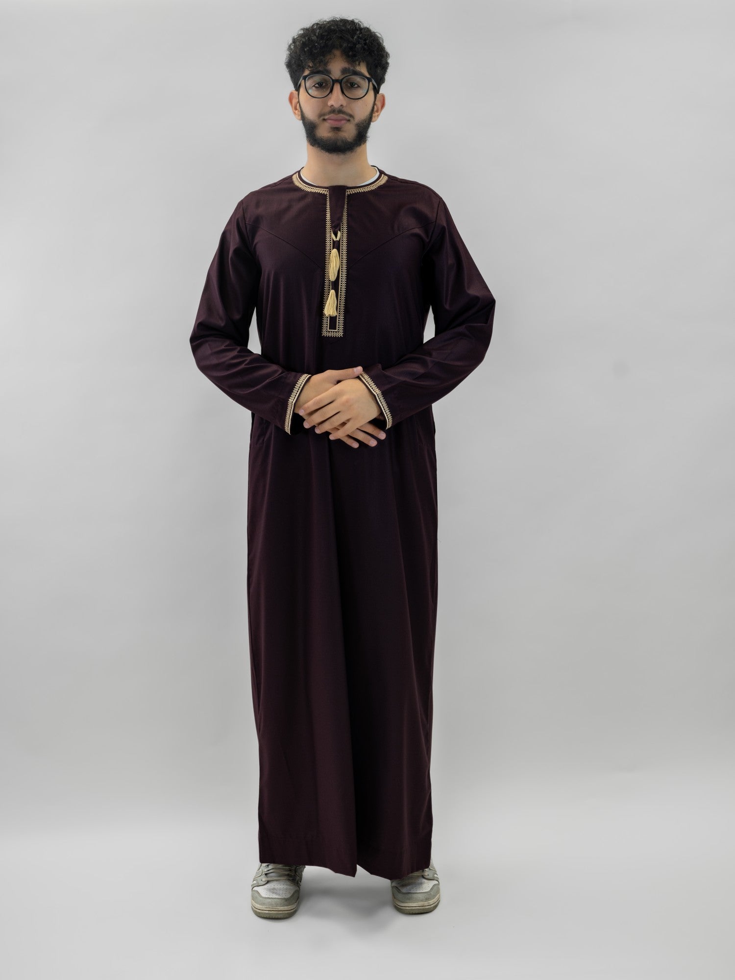 Burgundy emirati v neck with tarboush thobe for men, close-up of the fabric