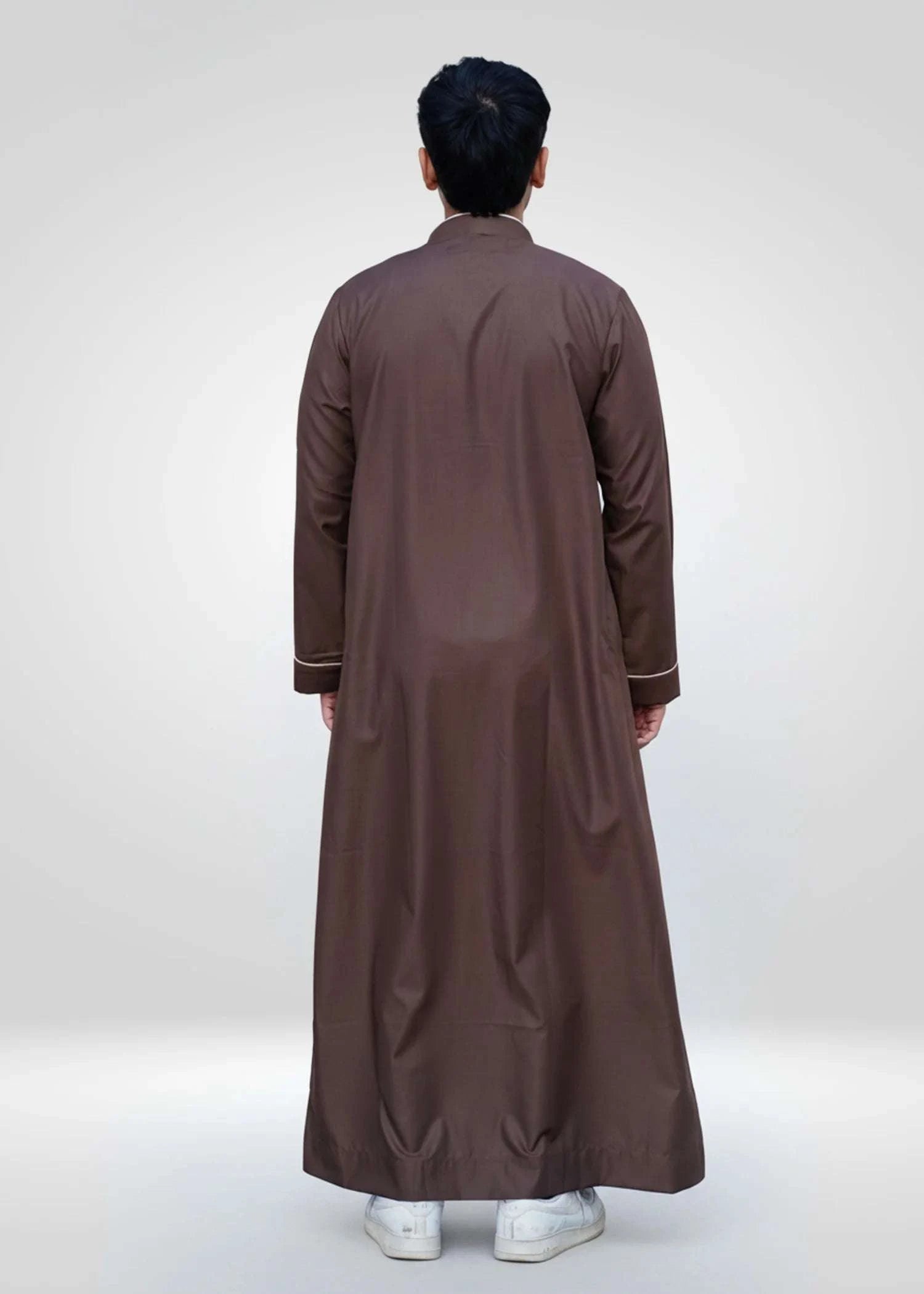 Chocolate brown embroidered thobe for men, worn by a model outdoors