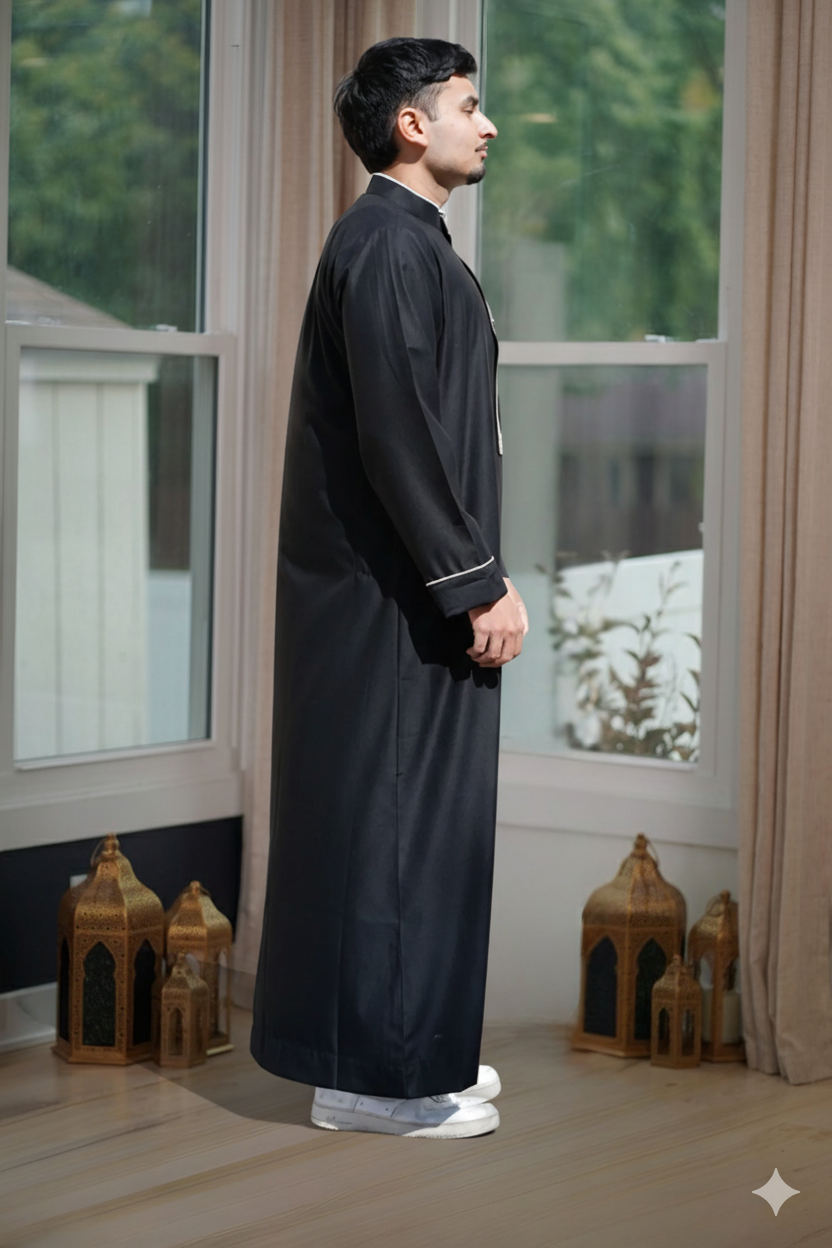 Macro shot of the premium gold embroidery stitching on the black men's fabric