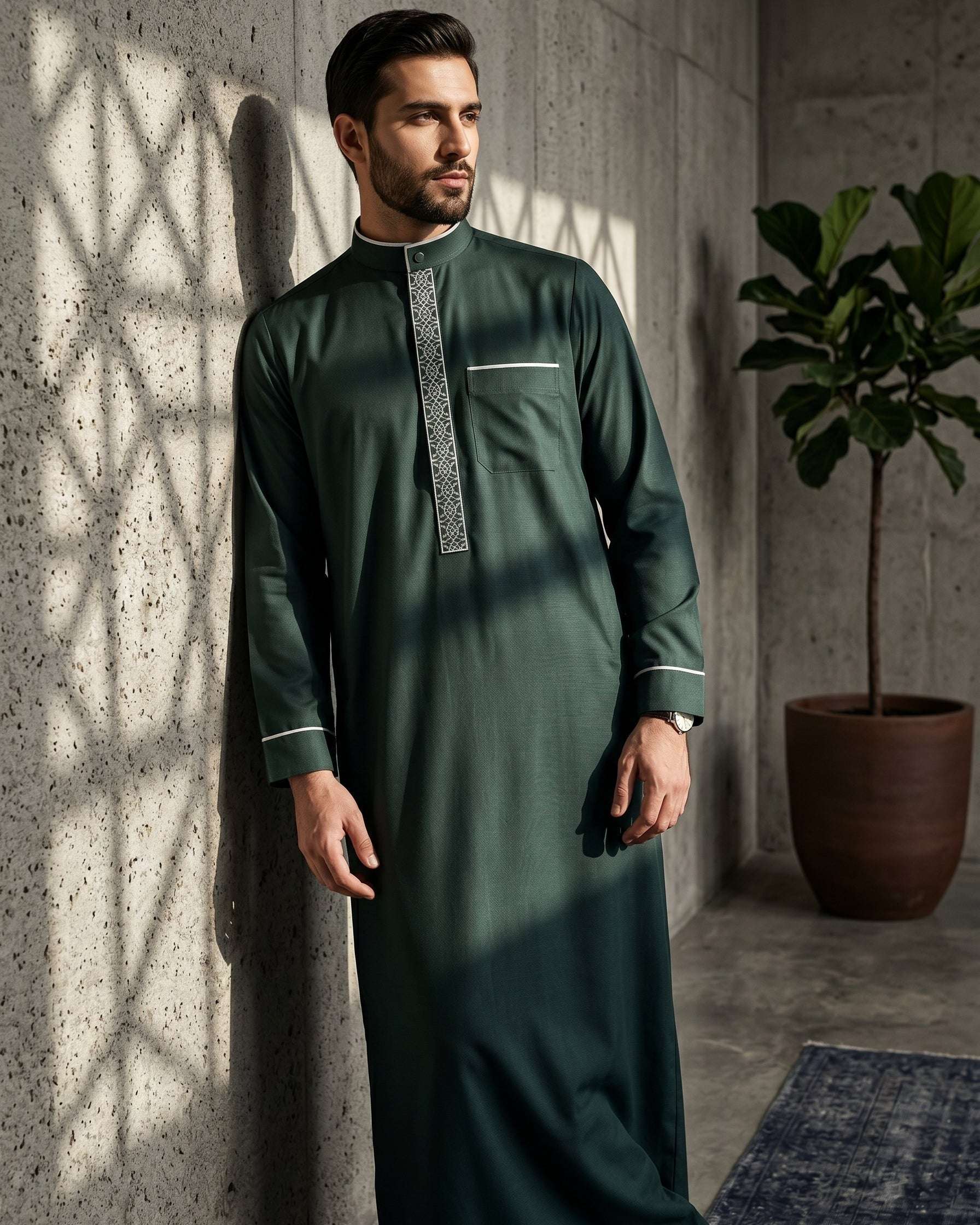 Emerald green executive thobe with geometric embroidery for men, close-up of the embroidered detailing