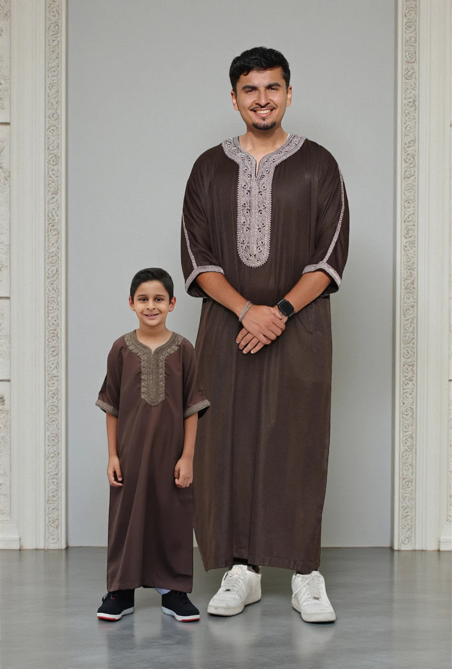The Topi Wala Father & Son matching set featuring Espresso Brown Moroccan Thobes with intricate beige embroidery on the V-neck and sleeves.
