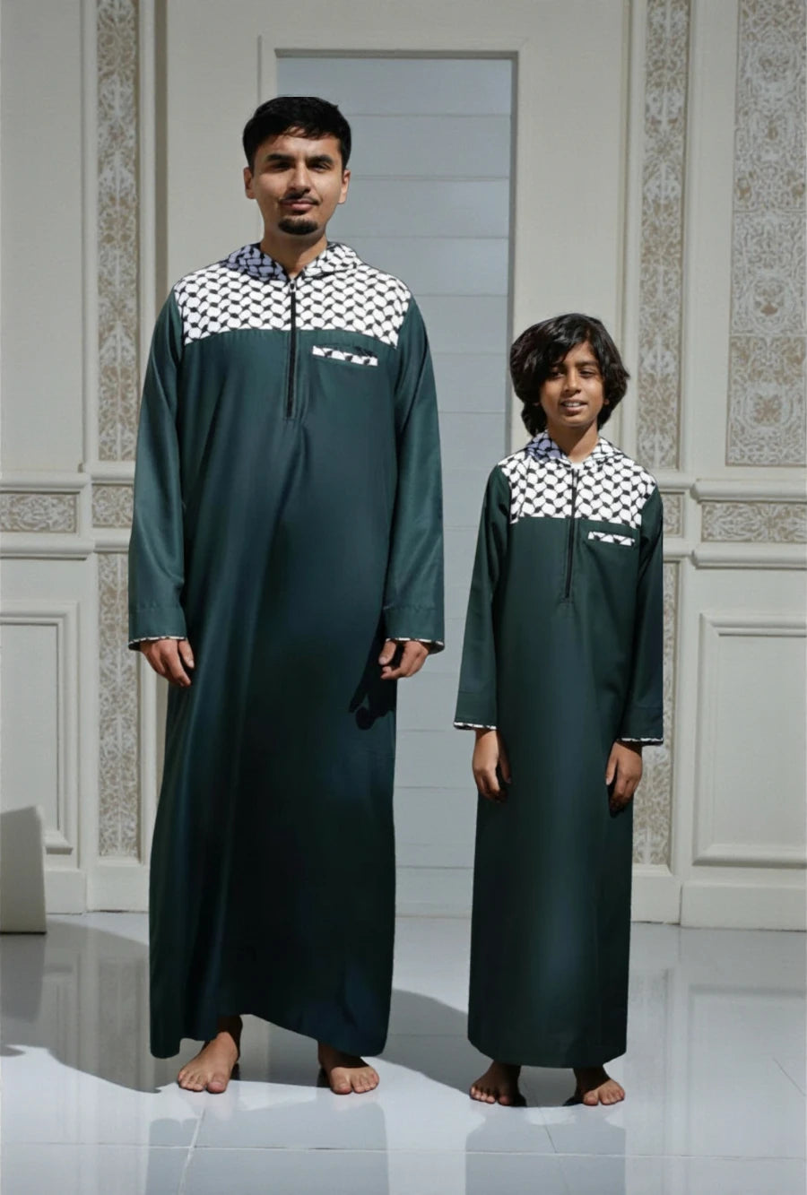 Father and son standing side-by-side wearing matching green modern hoodie thobes with black and white Kufiya patterns by The Topi Wala.