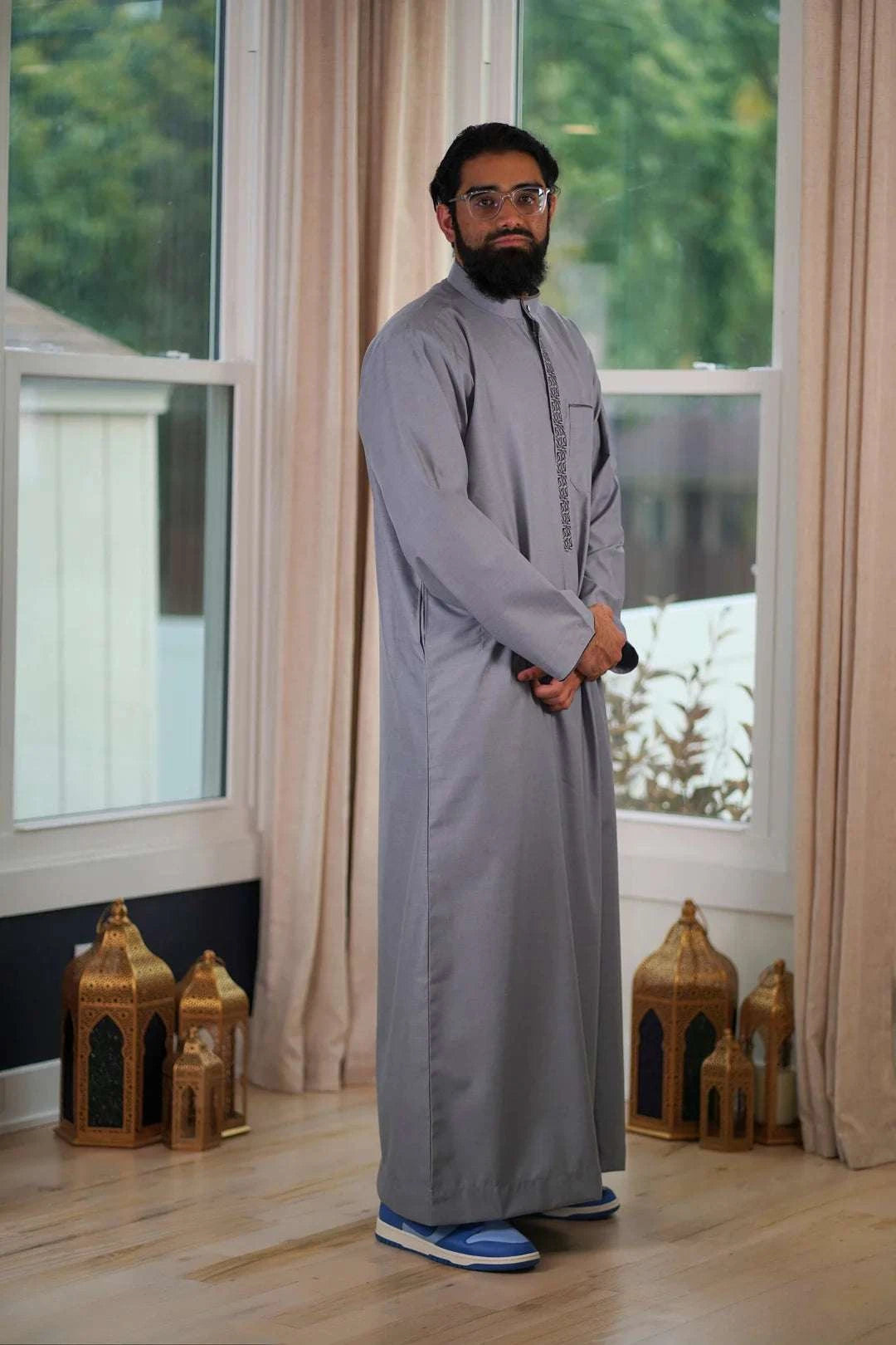 Gray embroidered thobe with mandarin collar for men, showing the length and sleeve line