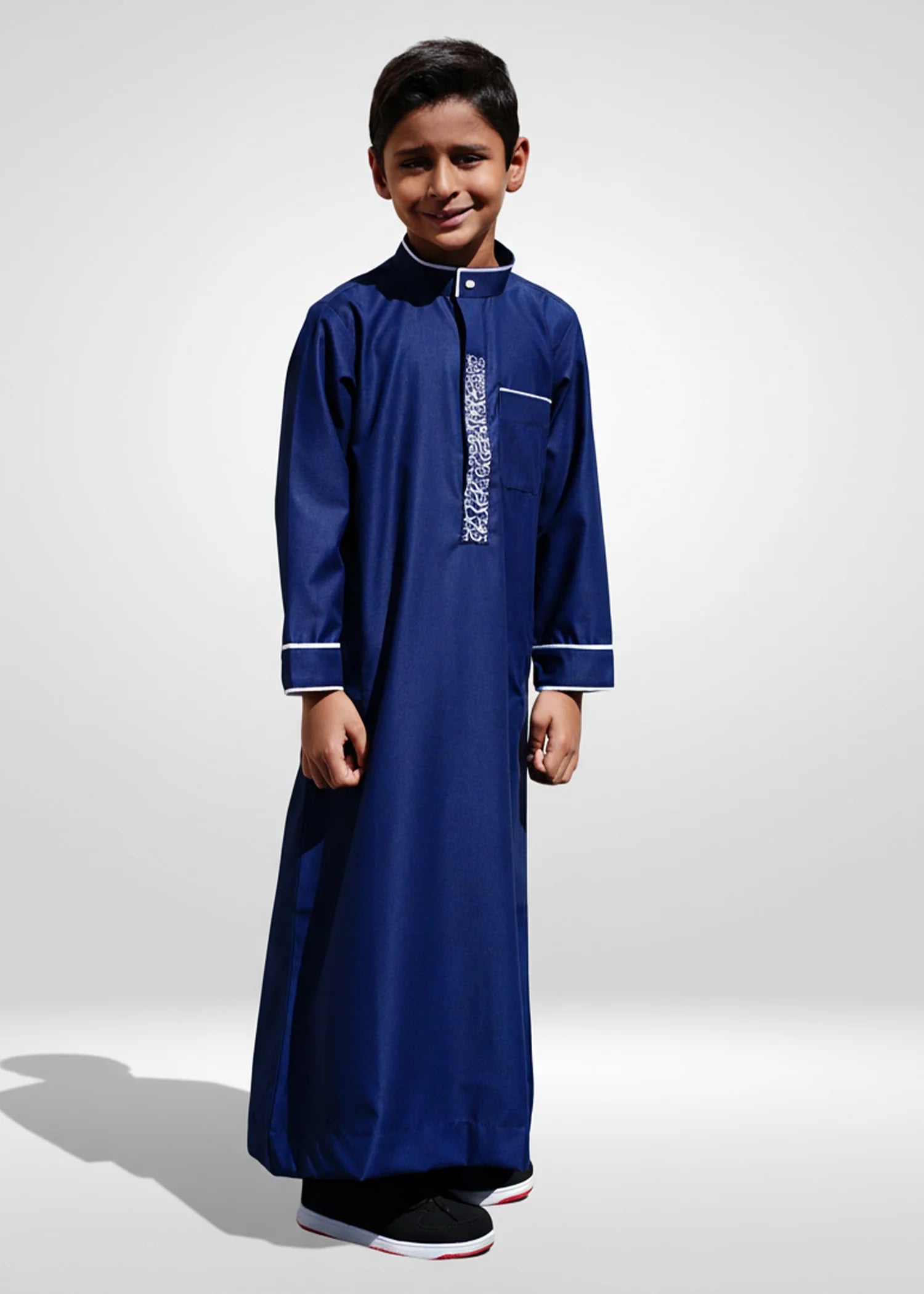 Side profile view of the boys navy thobe showing the structured formal fit