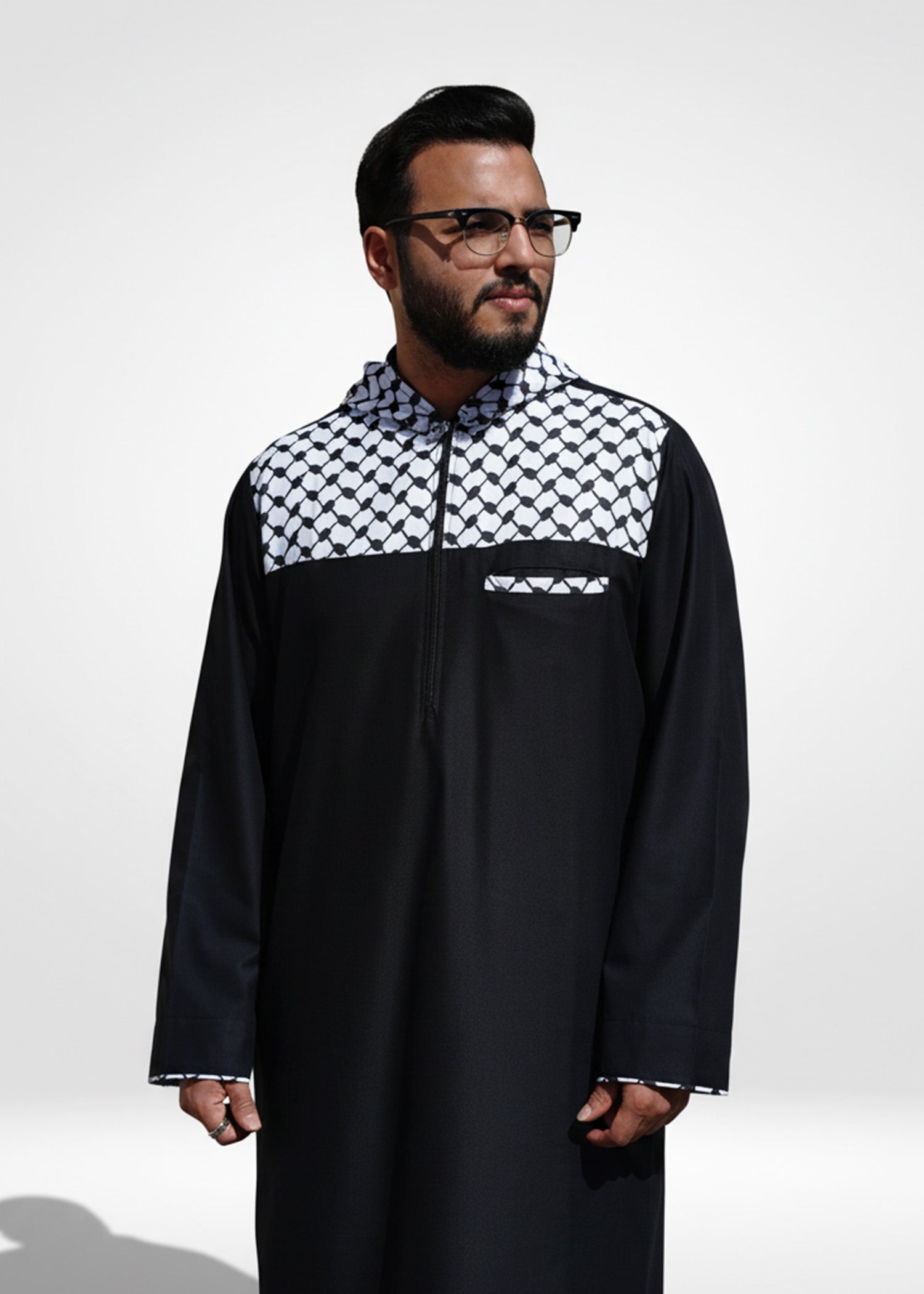 Close up of the bold black and white checkered design on the chest and hood of the men's jubba
