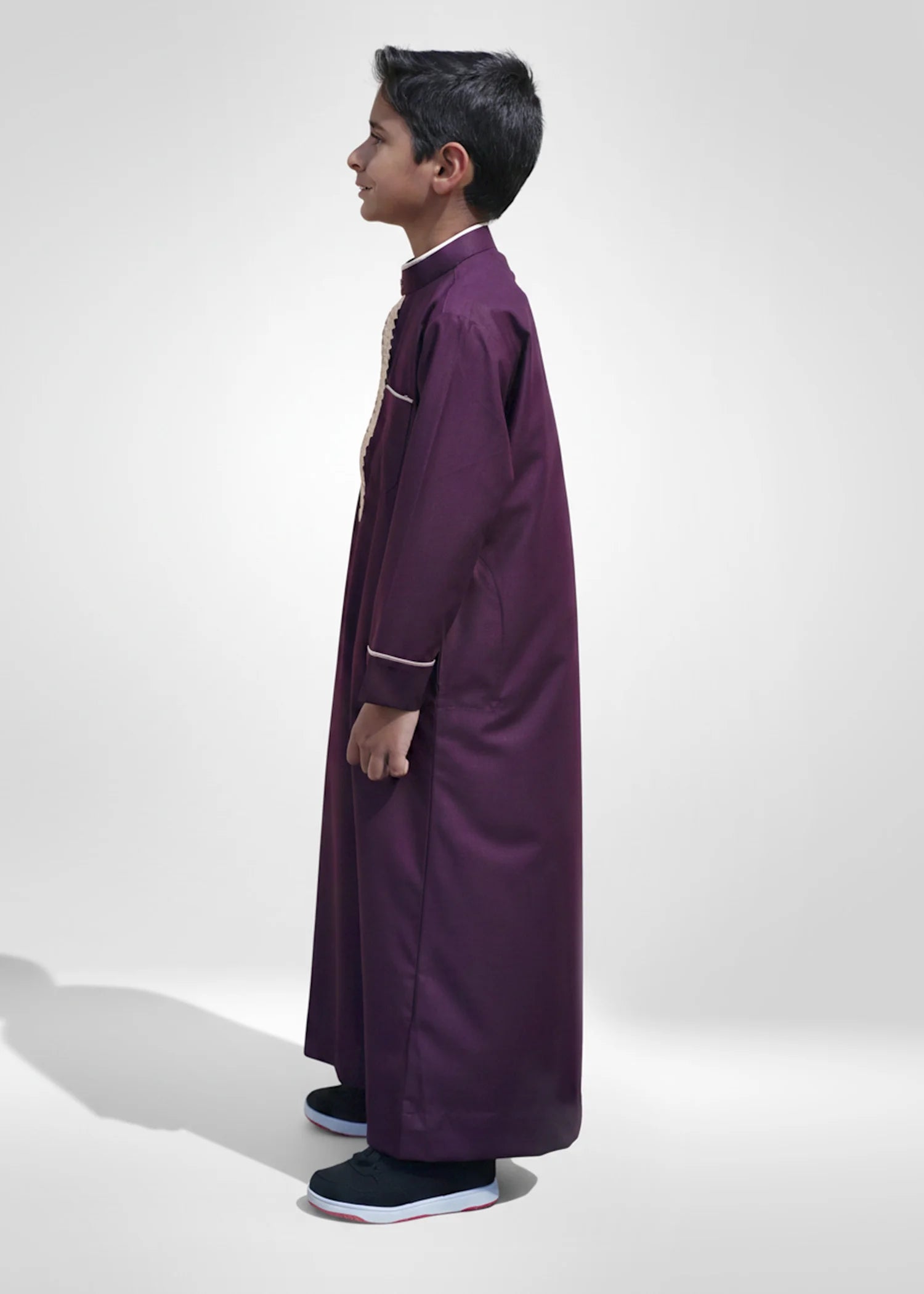 Detail of gold piping on the long sleeves and cuffs of the boys embroidered thobe
