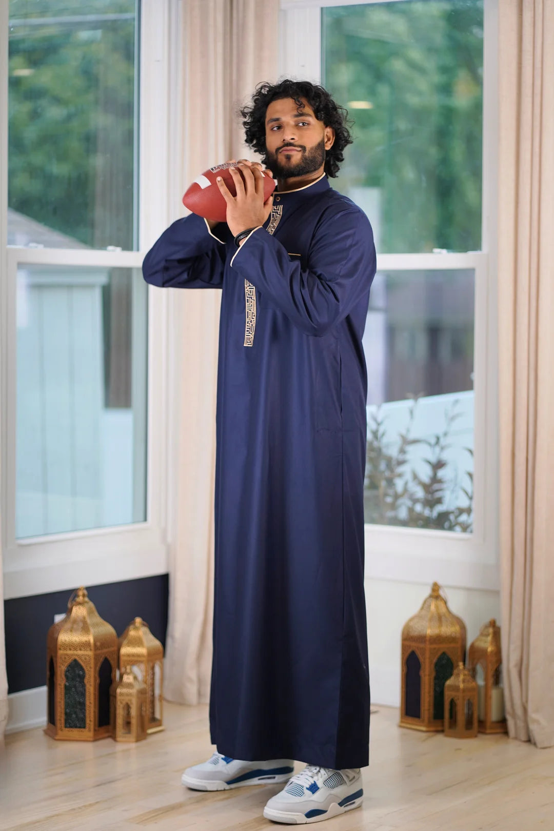 Side profile view of the men's navy thobe showing the structured formal fit