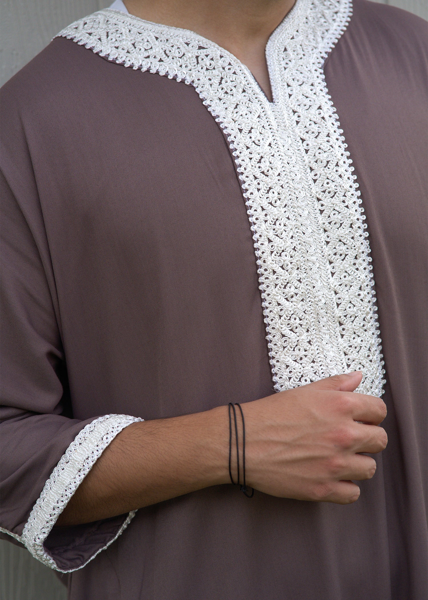 Close-up of authentic Moroccan stitchwork on the placket, showing the Grayish Pink Thobe detail and luxury Thobe quality.