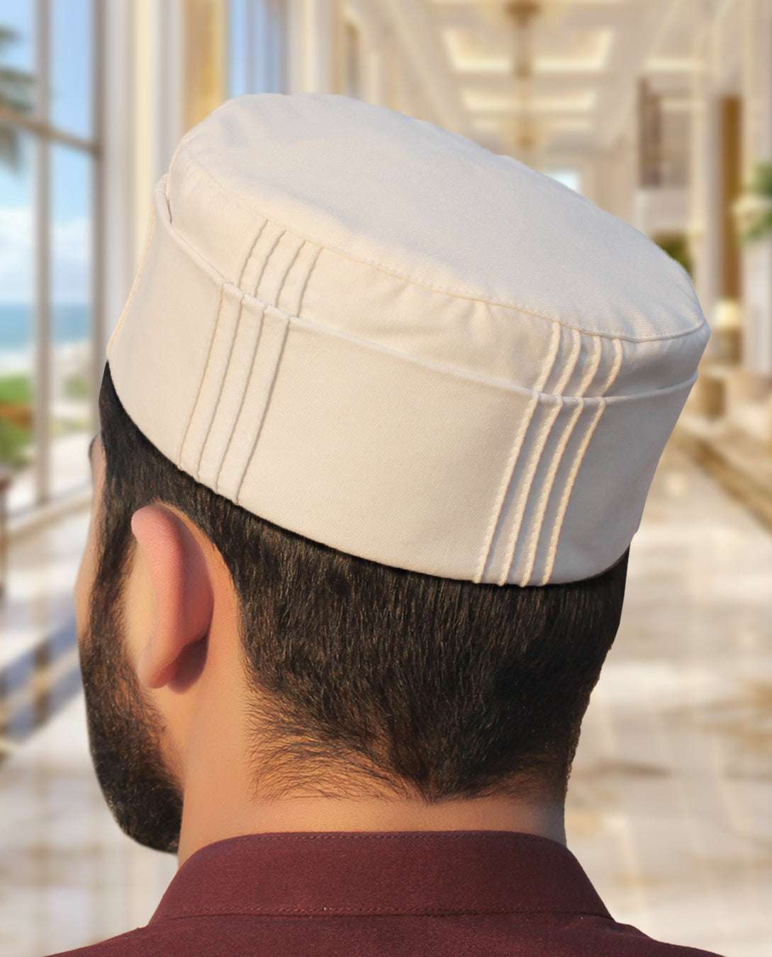 Off white pleated structured kufi prayer cap for men, close-up of the stitched crown