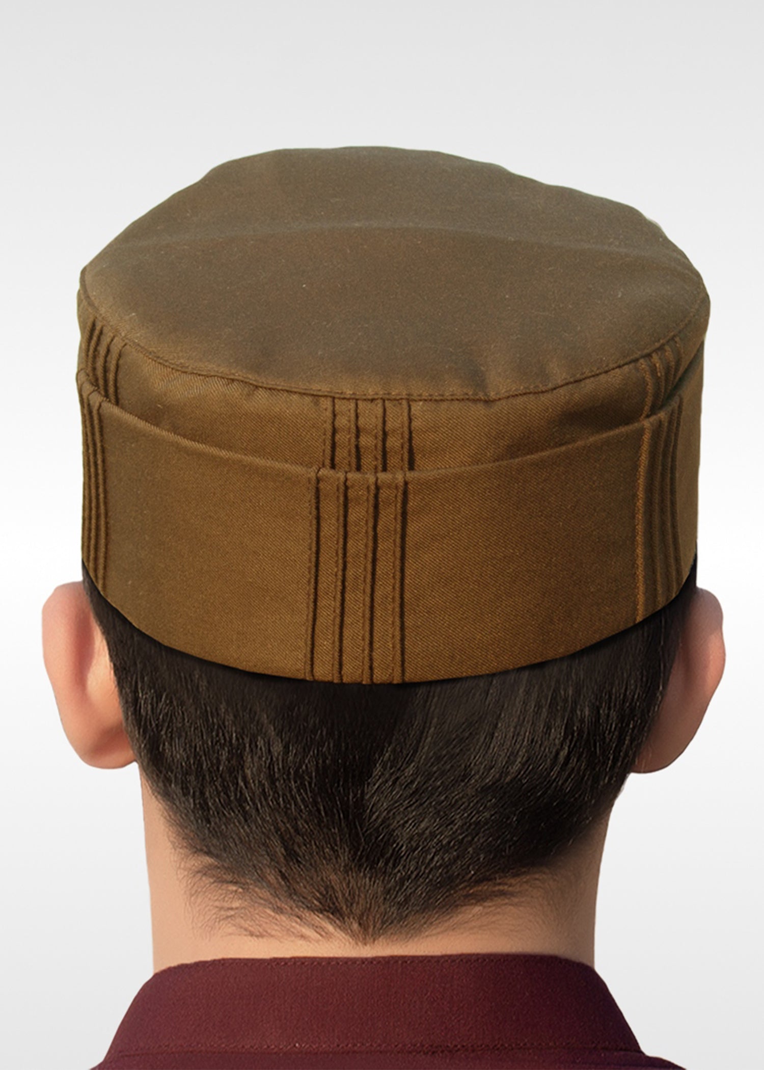 Front view of The Muneer Topi showing the neat pleated design and structured shape