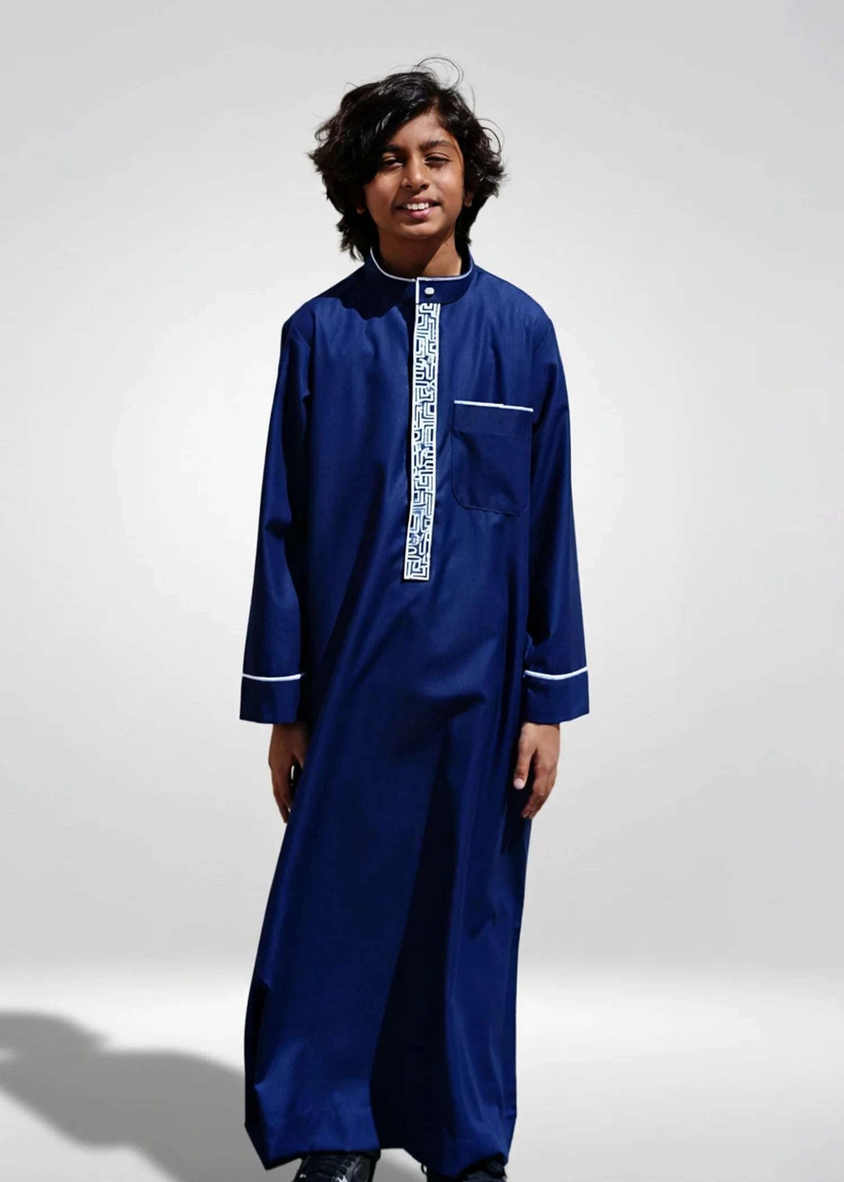 Navy blue embroidered thobe with silver geometric pattern for boys, full front view