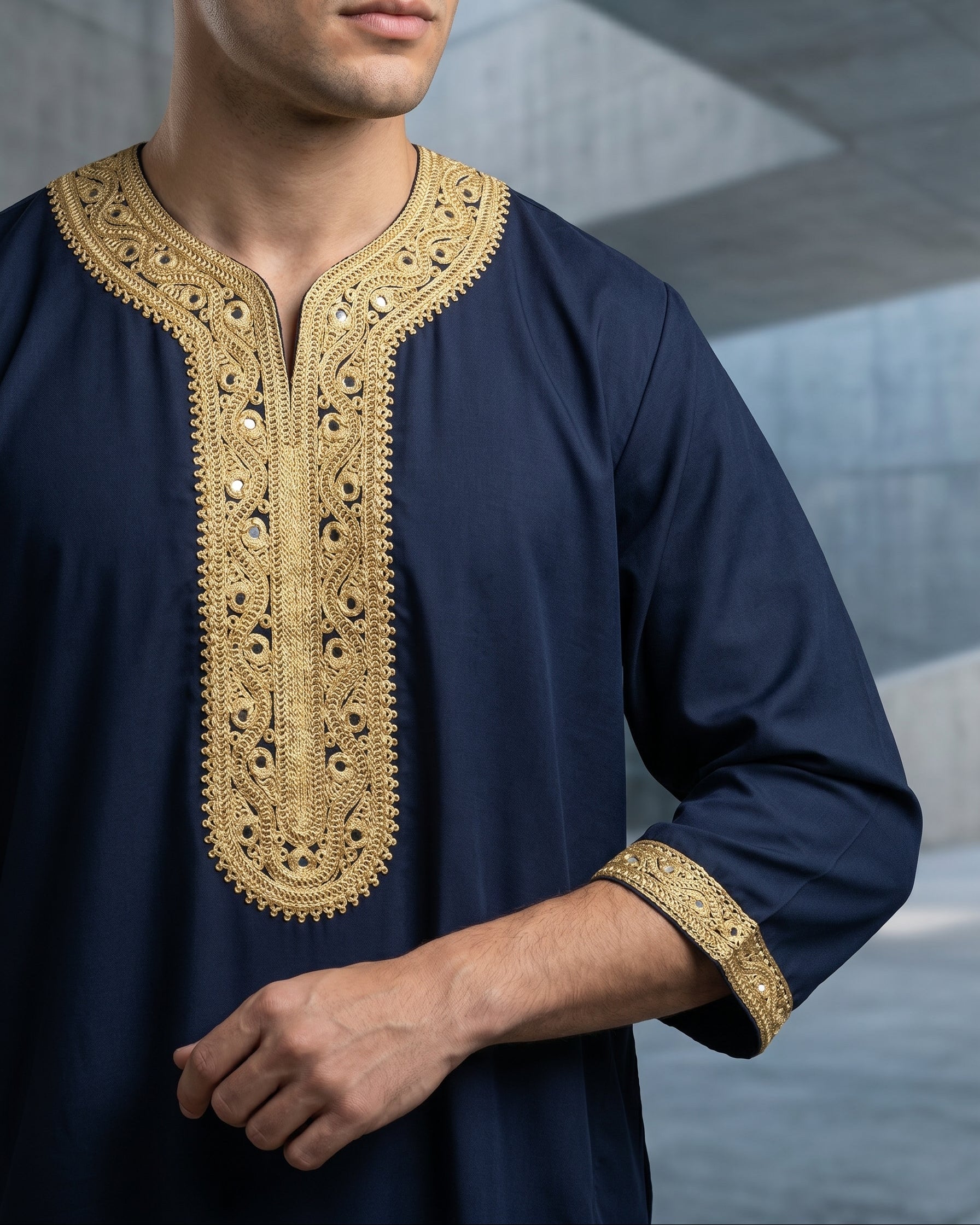 Close up of premium navy blue Moroccan thobe for men showing heavy gold embroidered jubbah details, traditional Islamic clothing, modest menswear, designer Sunnah wear, formal Eid outfit.

