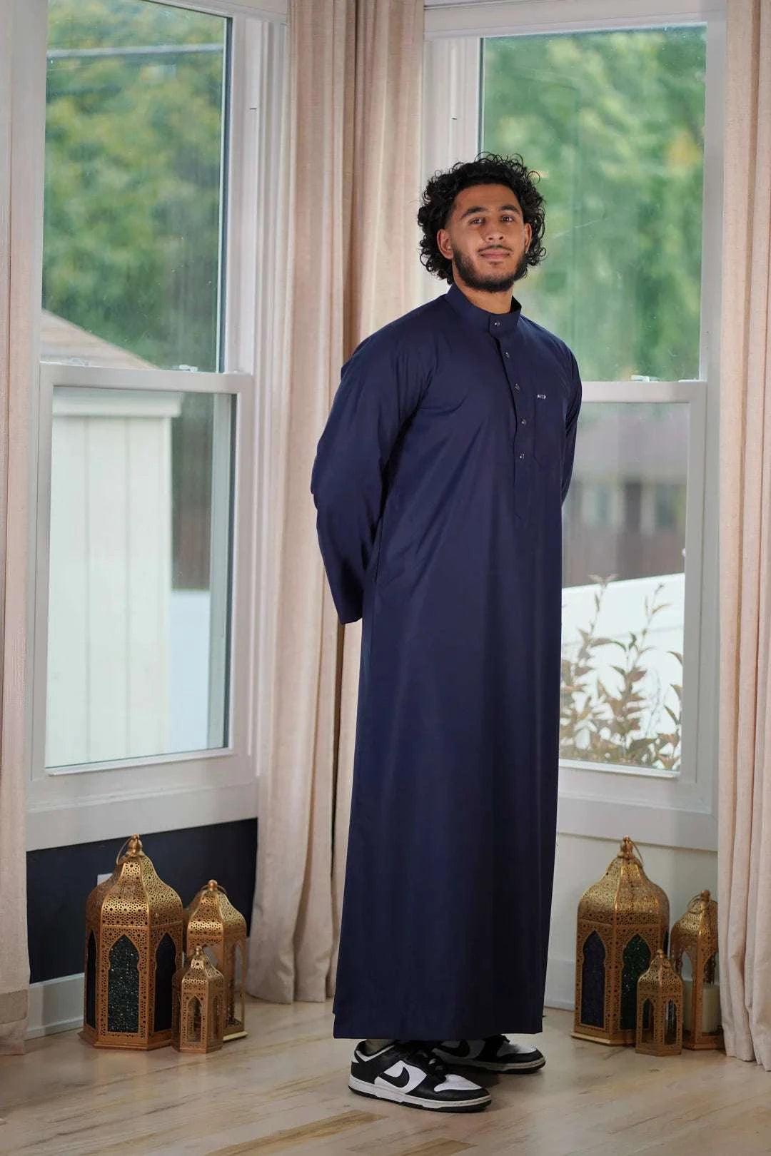 Navy blue thobe with mandarin collar for men, showing the length and sleeve line