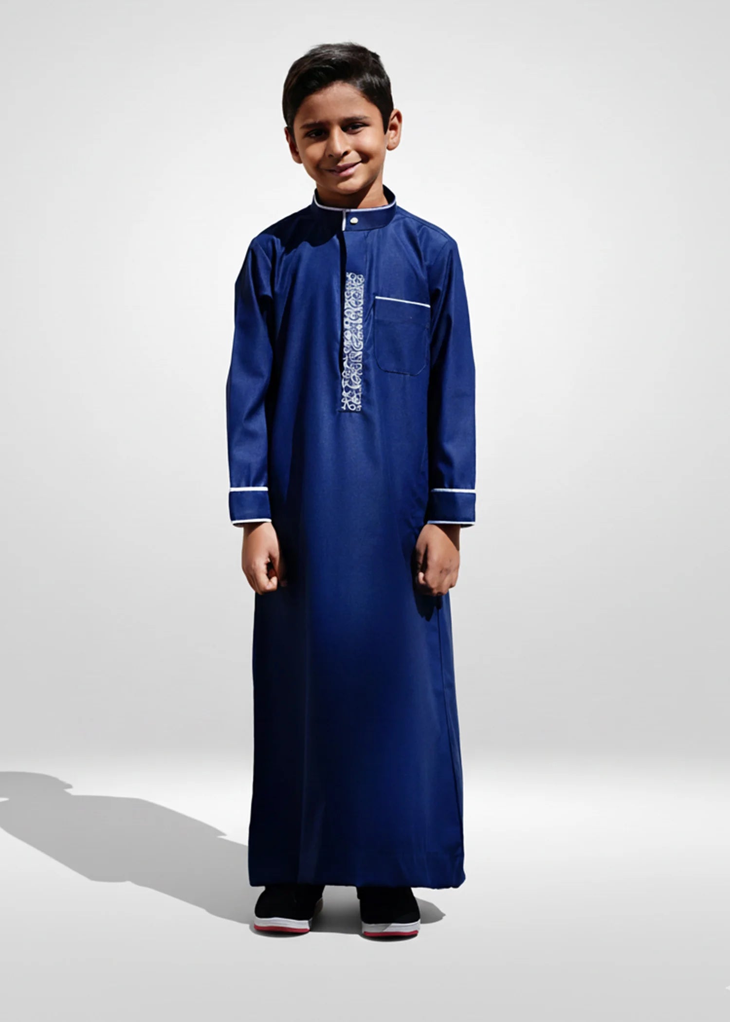 Front view of the Navy Blue & White Kids Embroidery Thobe showing the dark fabric and crisp white placket