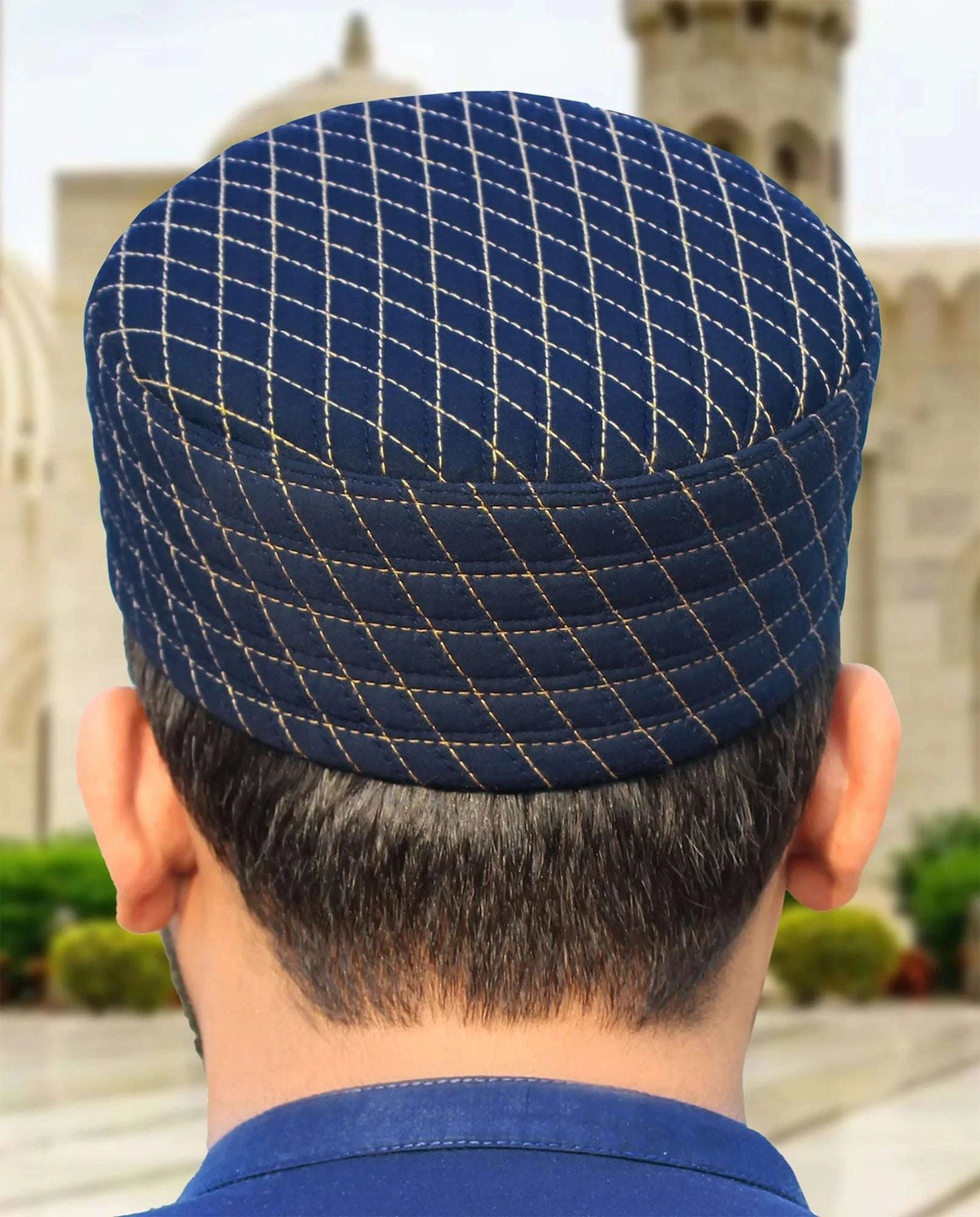 Navy blue quilted kufi prayer cap with white stitching, an everyday Sunnah essential