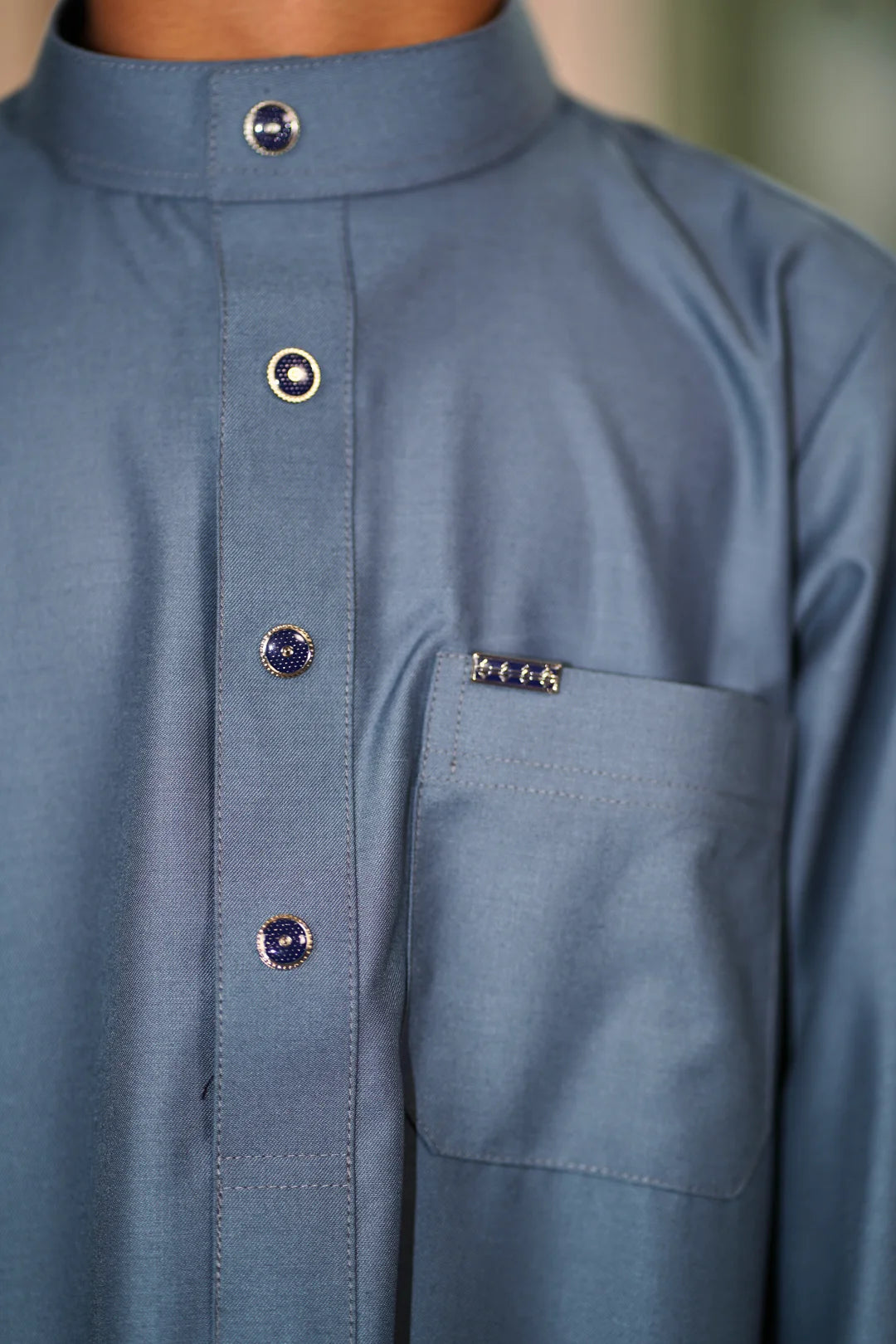 Back view of the Plain Dusty Blue Kids Thobe highlighting the clean drape and high-quality stitching.