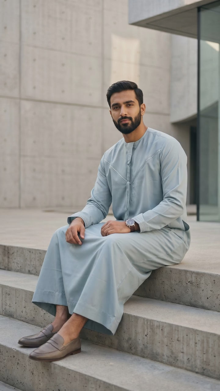 Authentic Moroccan style men's thobe in light blue, luxury Islamic menswear, modest apparel for Muslims, traditional Middle Eastern clothing, premium summer gandora with tassel, best Eid clothing for men, modest wardrobe essentials.