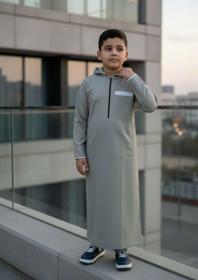Sage green hooded thobe with sporty half-zip for boys, close-up of the zip pull