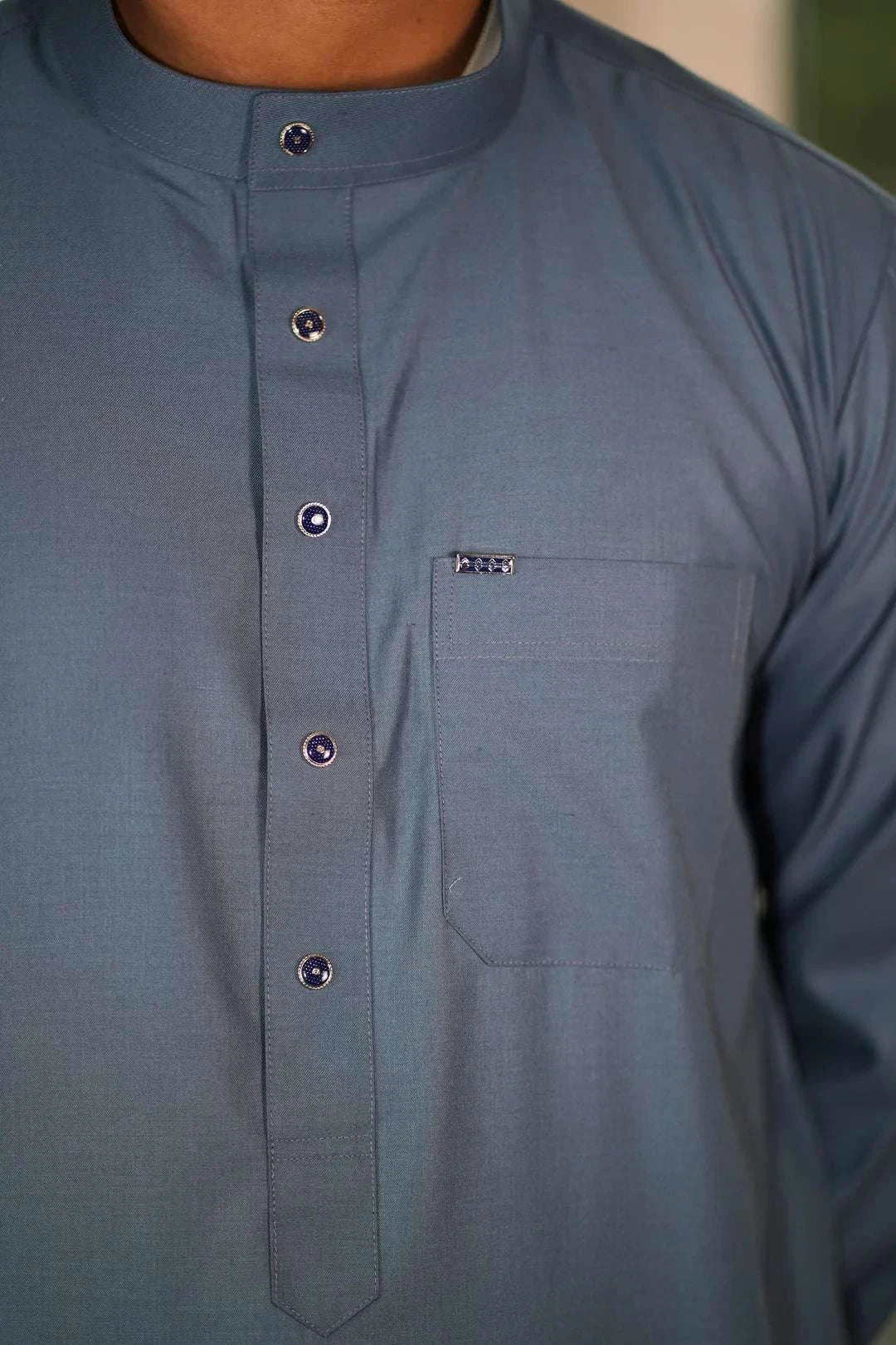 Slate blue thobe with everyday mandarin collar for men, styled on a model outdoors