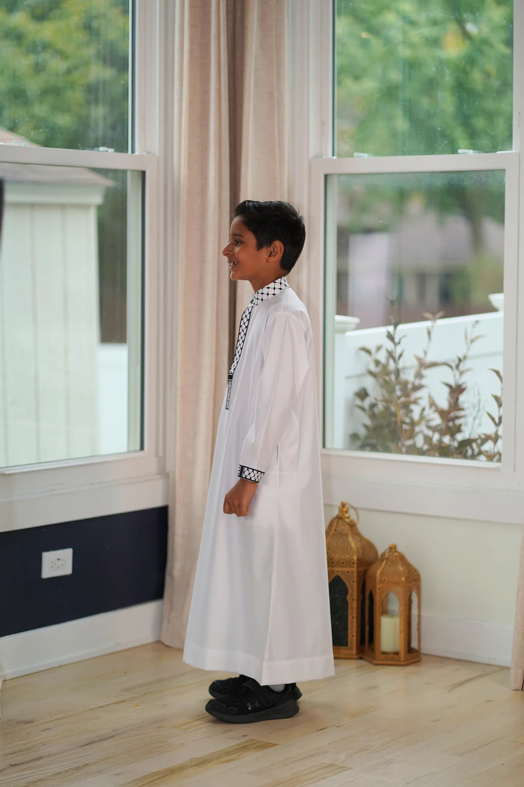 Macro shot displaying the smooth white fabric texture next to the detailed embroidery