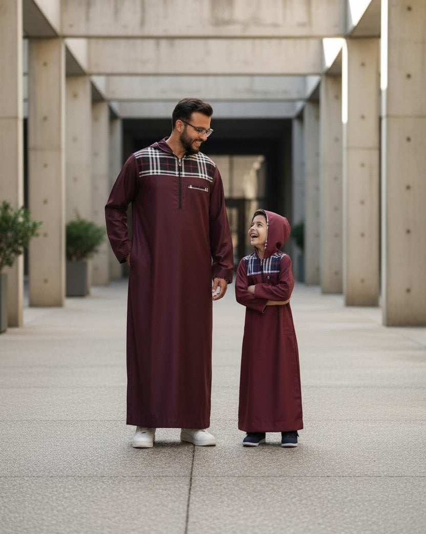 The Topi Wala father and son matching maroon thobes with checkered hood and pocket details.