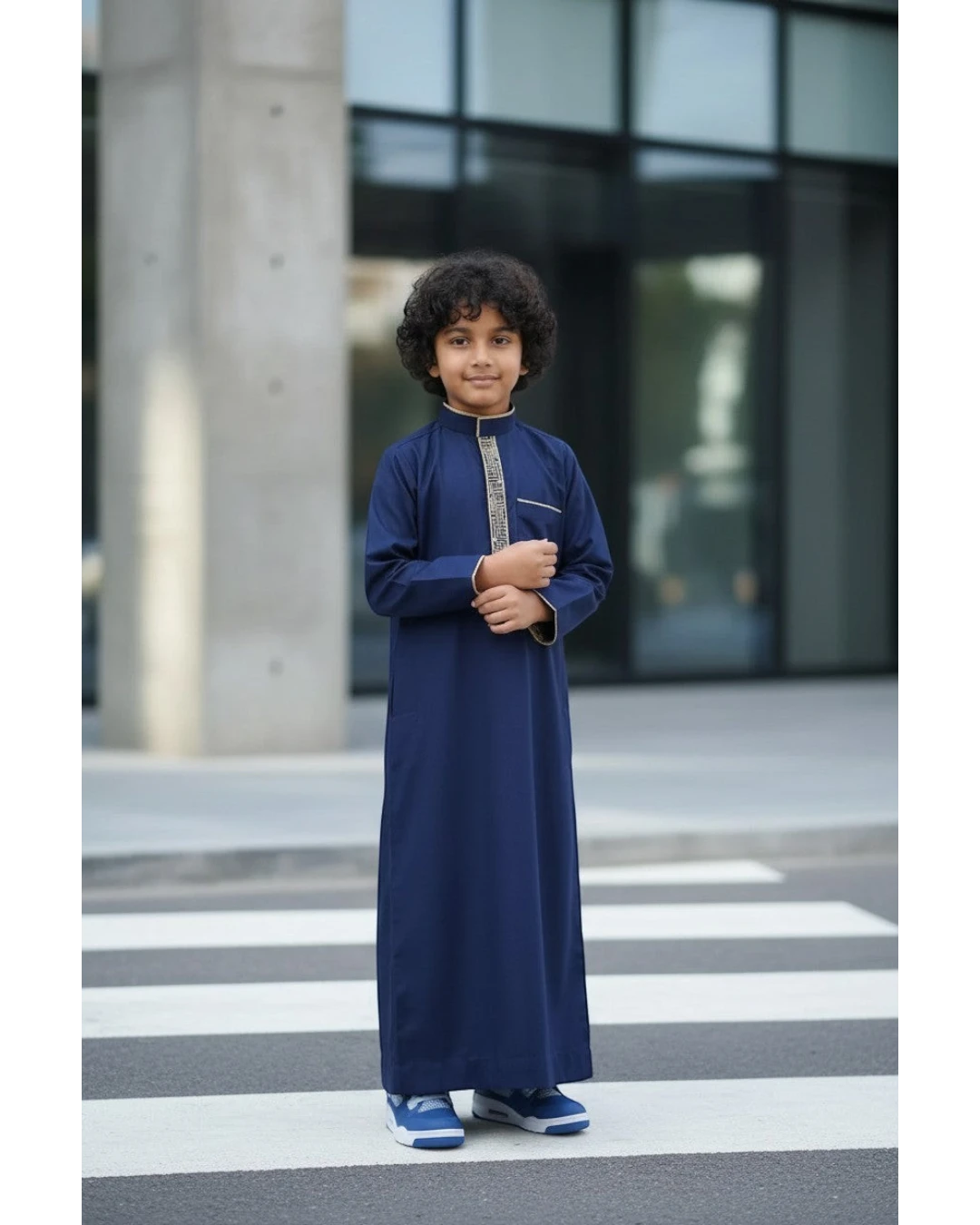 The Topi Wala navy blue boys thobe with beige and gold embroidery on the collar and cuffs. Long sleeves.