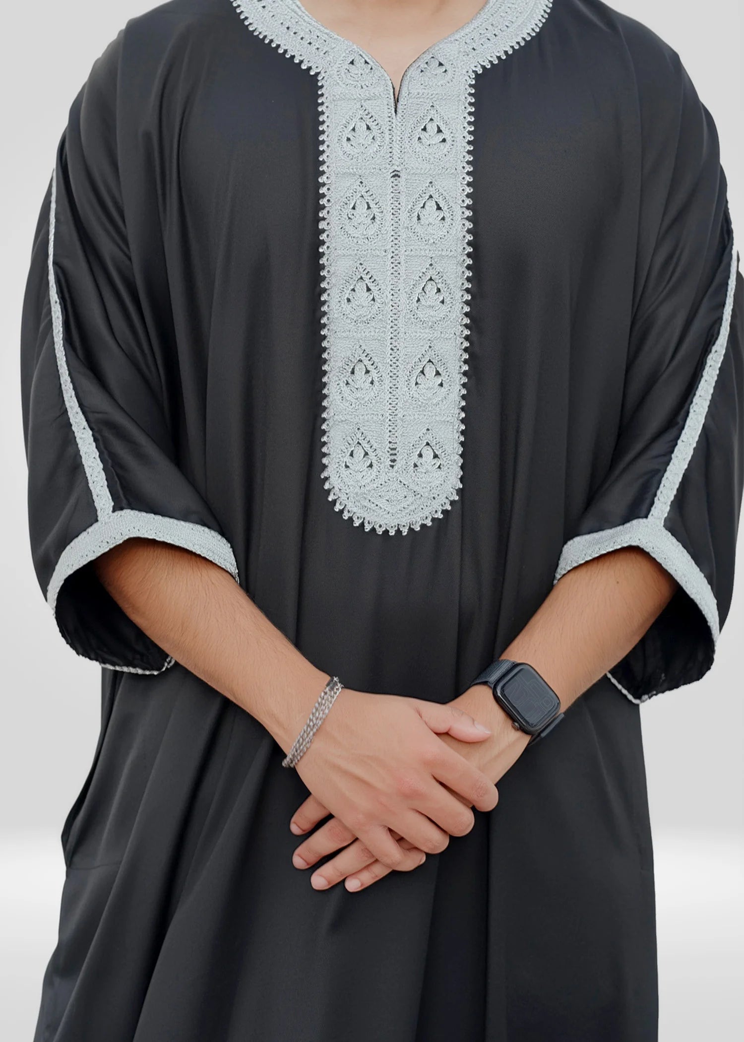 Close-up shot of the geometric gold-toned embroidery and the mandarin collar neckline.