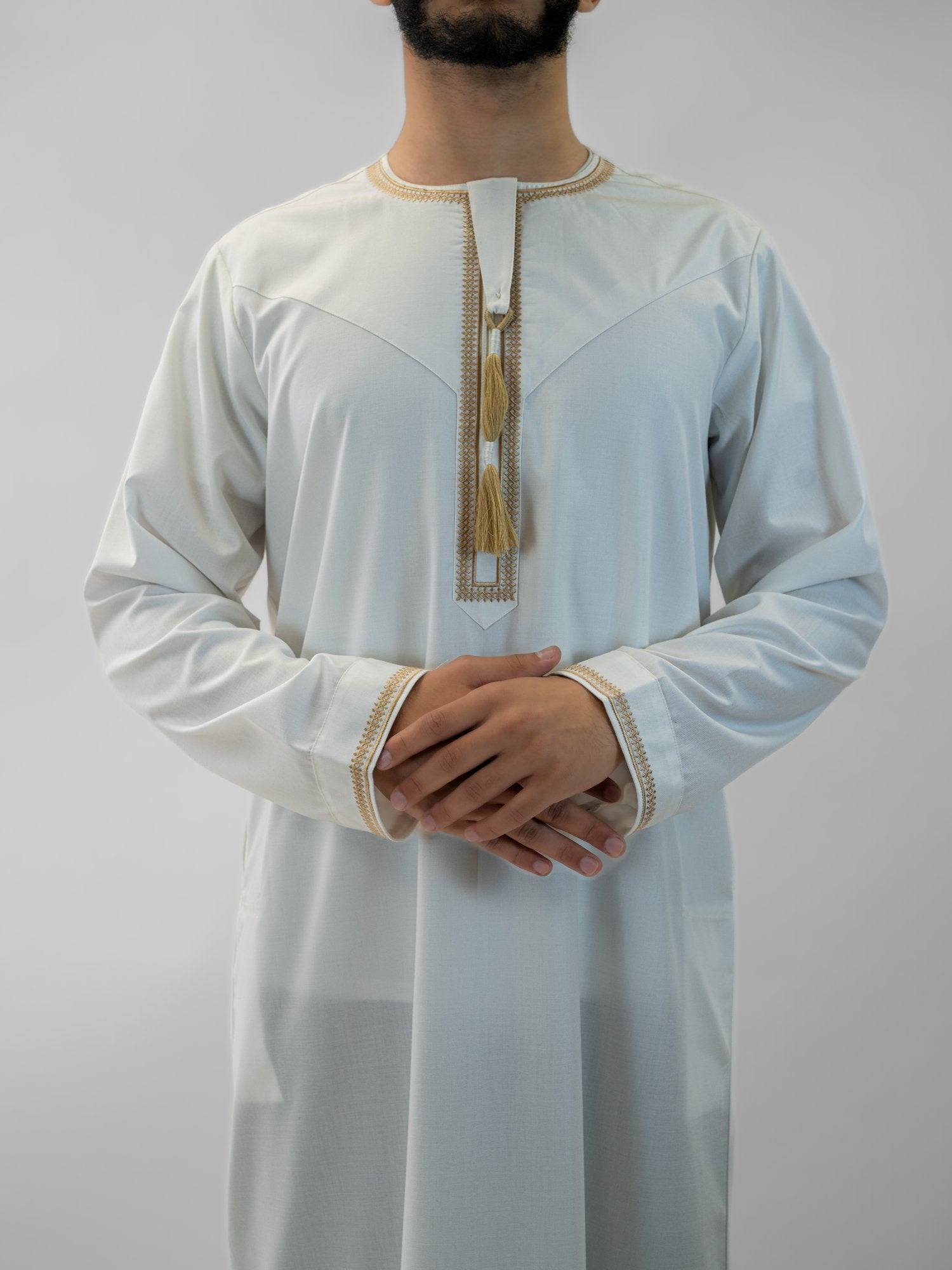 White emirati with tarboush cap thobe for men, close-up of the collar and buttons