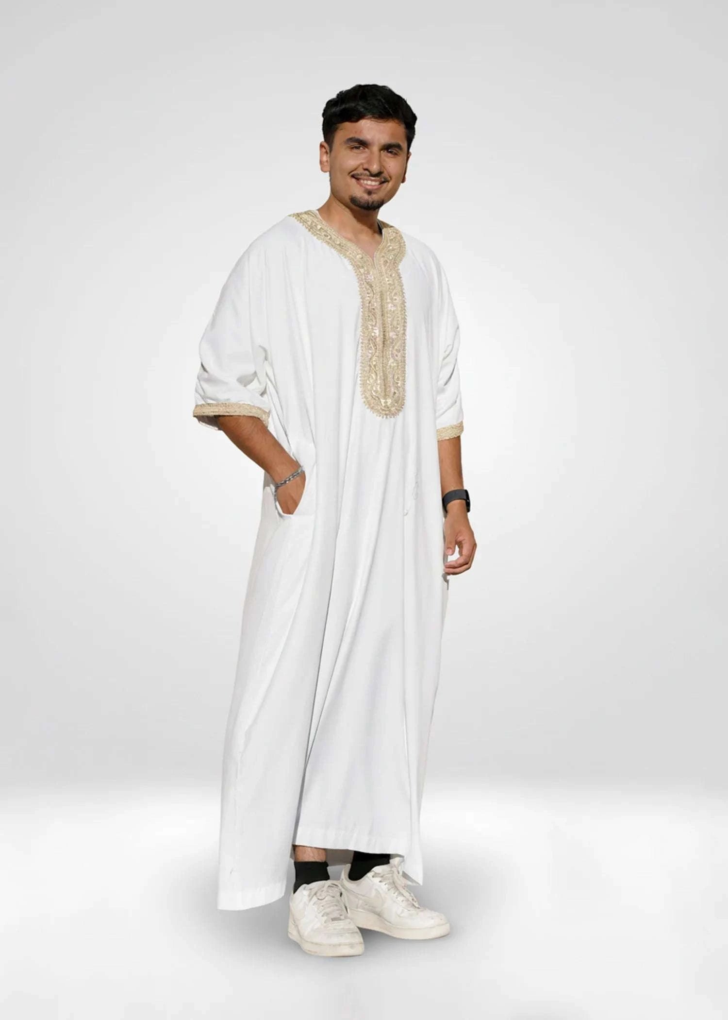 White and gold Moroccan thobe for men, worn by a model outdoors