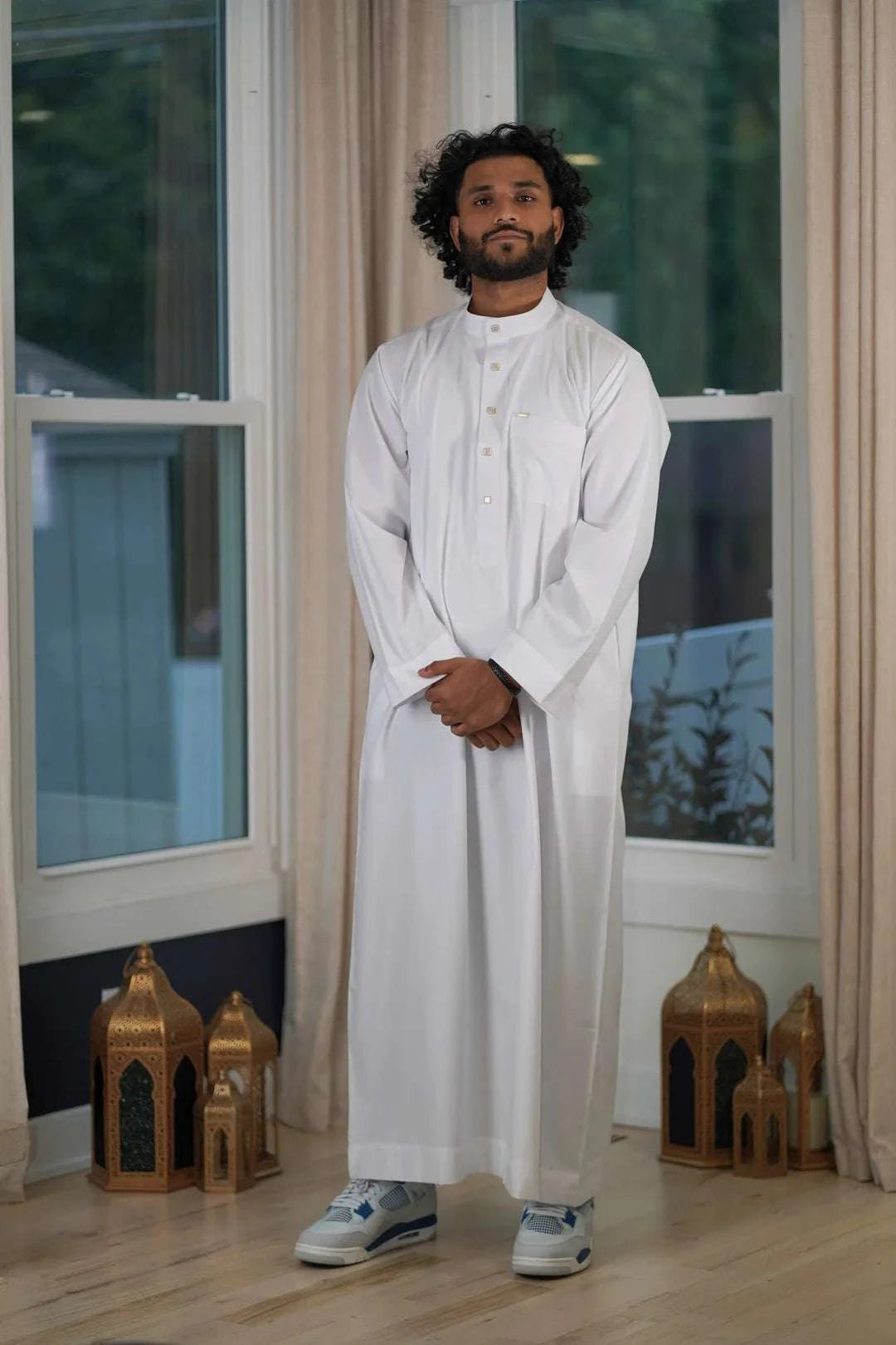 White thobe with mandarin collar for men, worn by a model outdoors