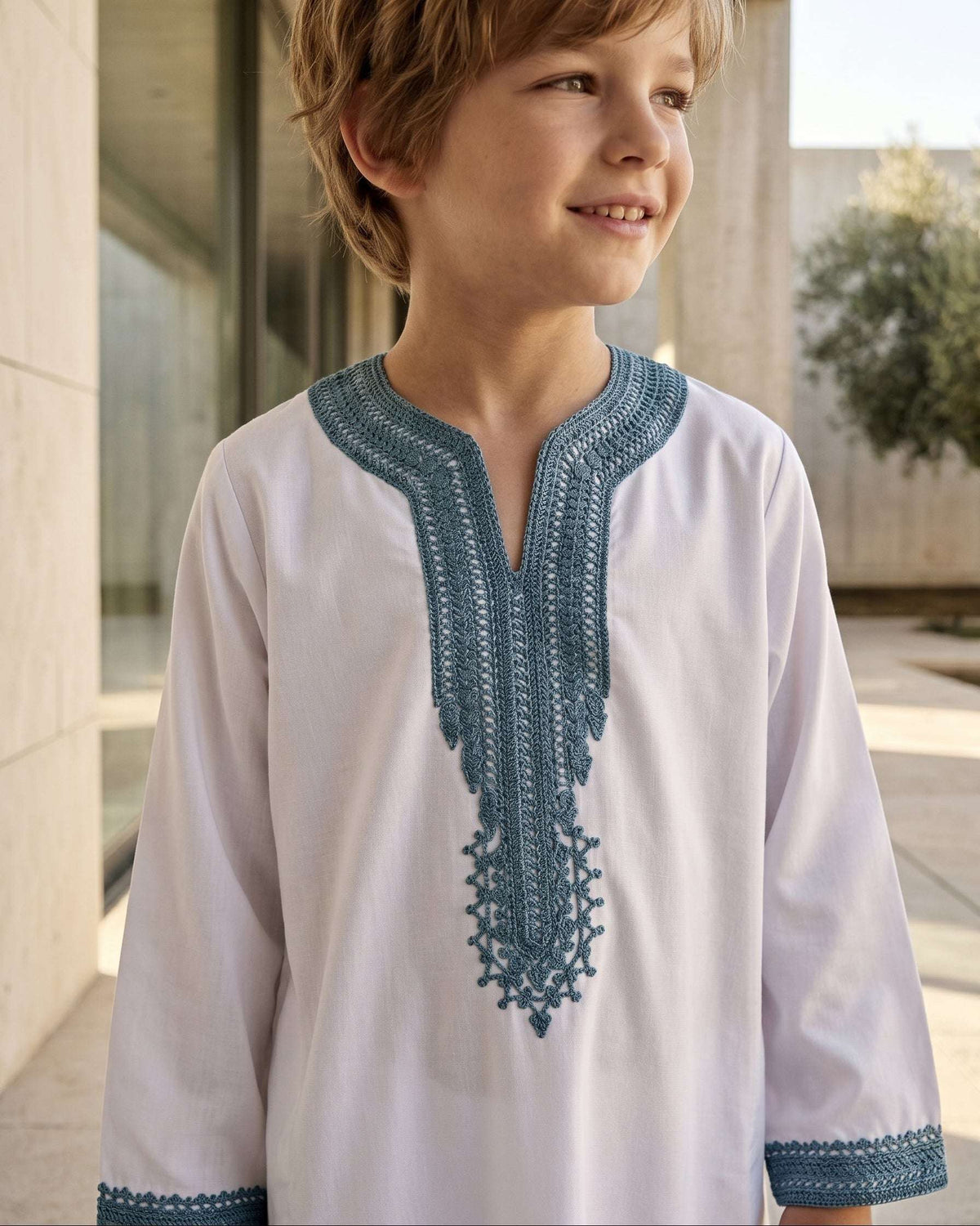 White Moroccan gandora with teal embroidery for boys, close-up of the embroidered detailing